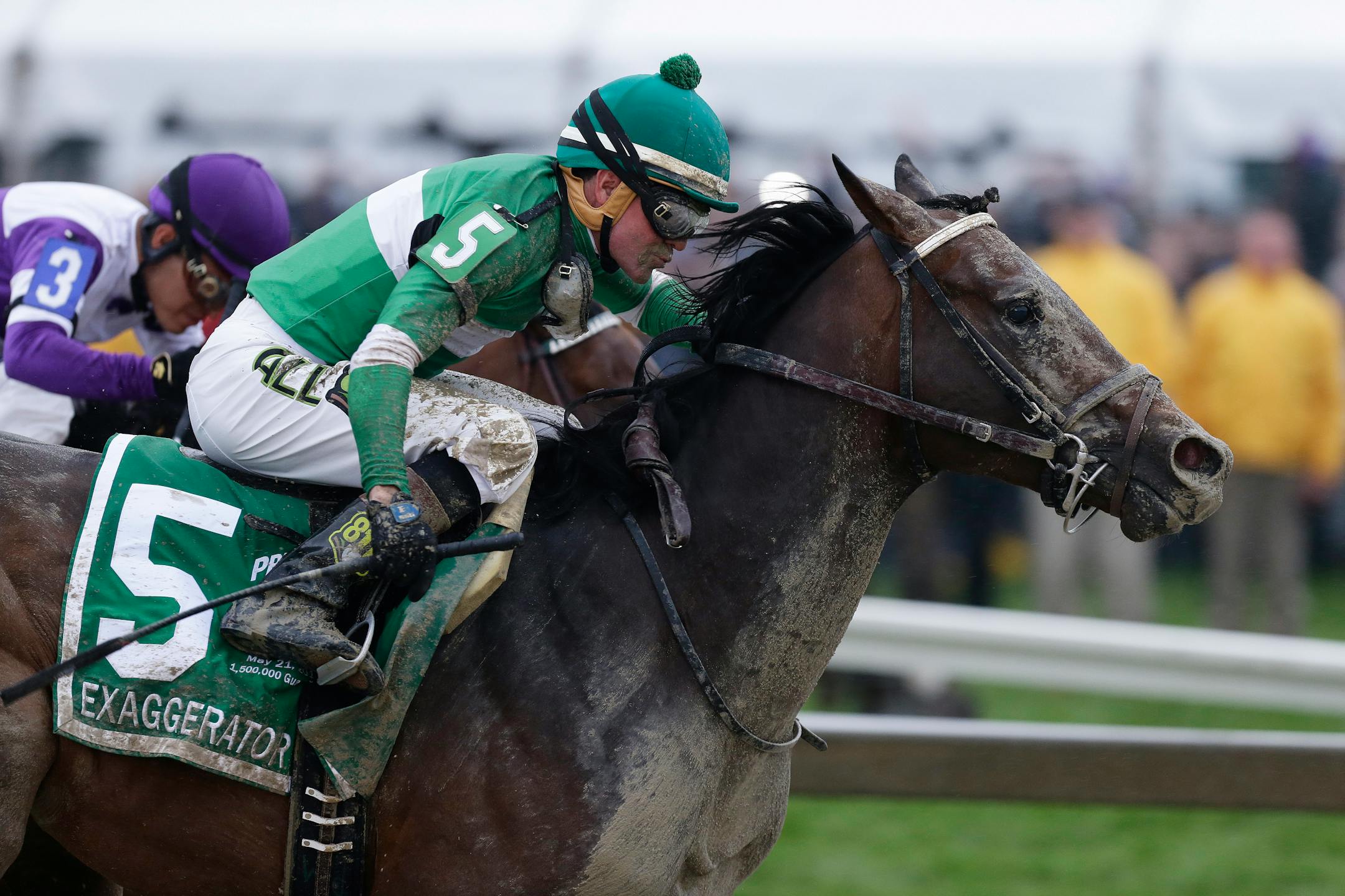 Exaggerator with Kent Desormeaux aboard moves past Nyquist with Mario Gutierrez during the 141st Preakness Stakes horse race at Pimlico Race Course, Saturday, May 21, 2016, in Baltimore. Exaggerator won the race. (AP Photo/Garry Jones)