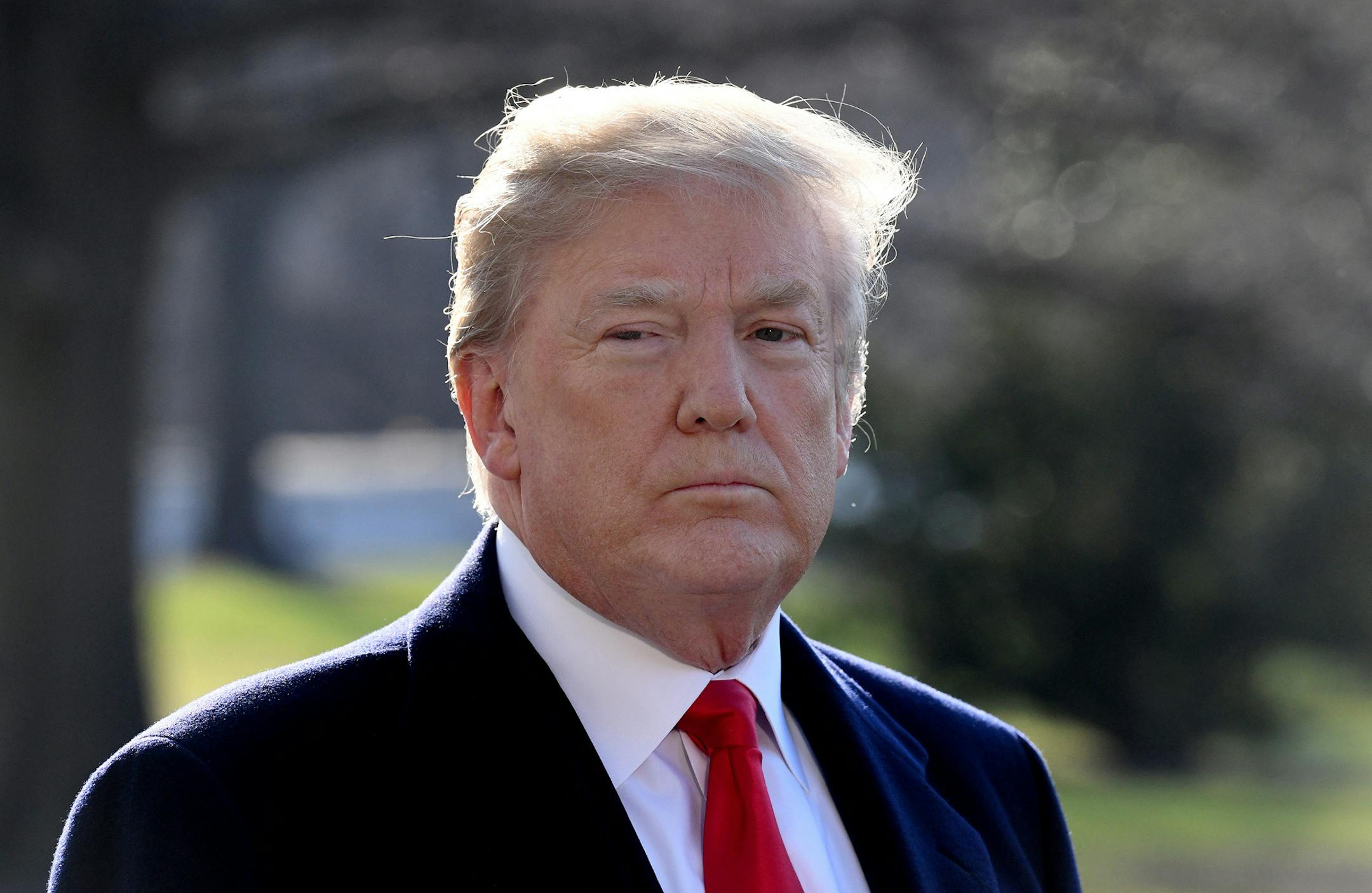U.S. President Donald Trump answers questions from the media as he departs the White House on Tuesday, March 13, 2018 in Washington, D.C. Trump is traveling to San Diego, Calif. to see the border wall prototypes.