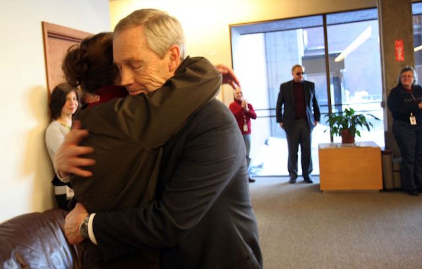 Judge Robert Carolan hugged his wife, Meg, after the ceremony to honor his retirement. Of his opportunity to preside over Kosovo's Constitutional Court for 18 months, the Mendota Heights judge says, he's "privileged."