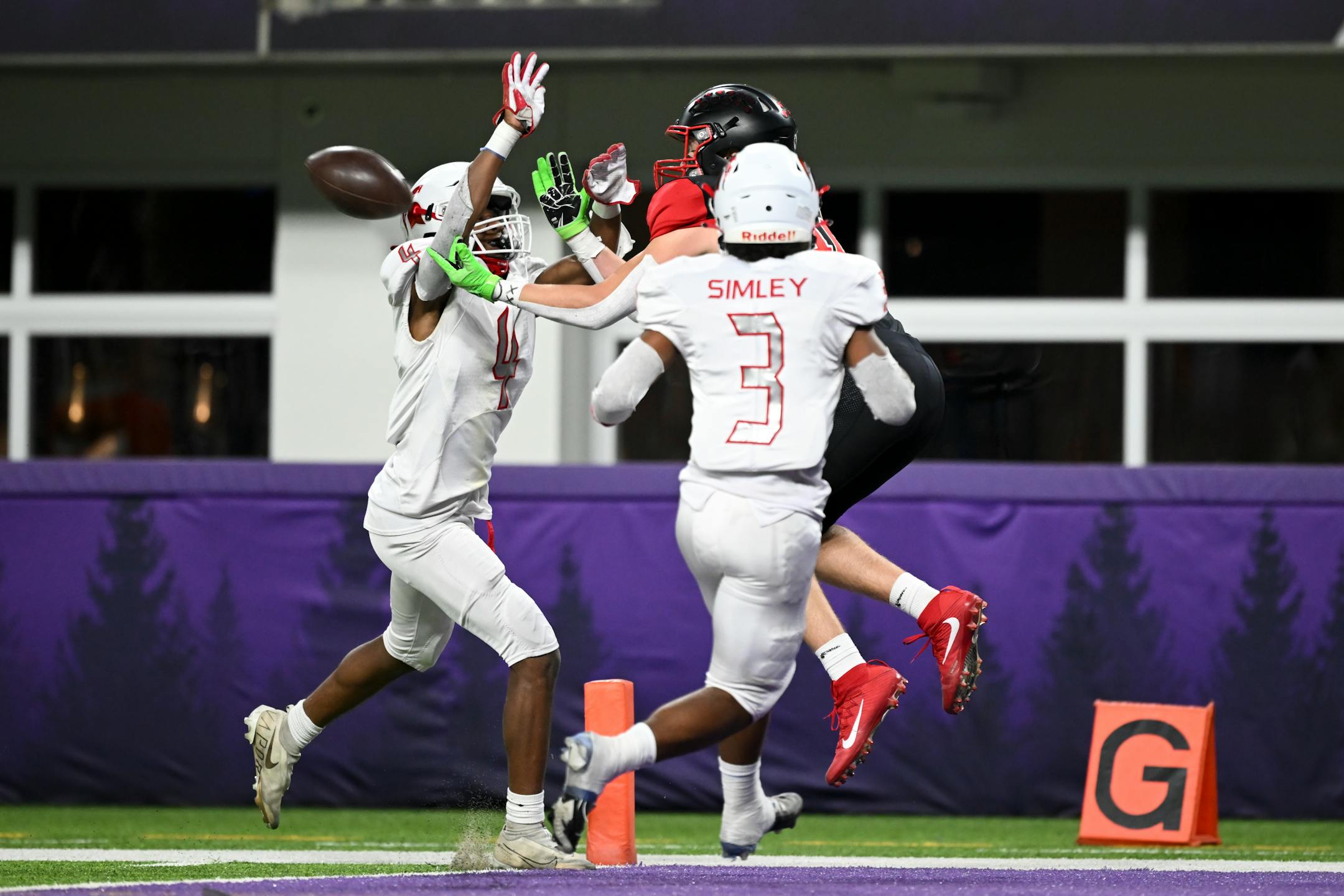 Rocori wide reciever Adam Langer (12) misses the catch and bobbles the ball back to teammate Gabe Johnson (22) for a touchdown during the first half.