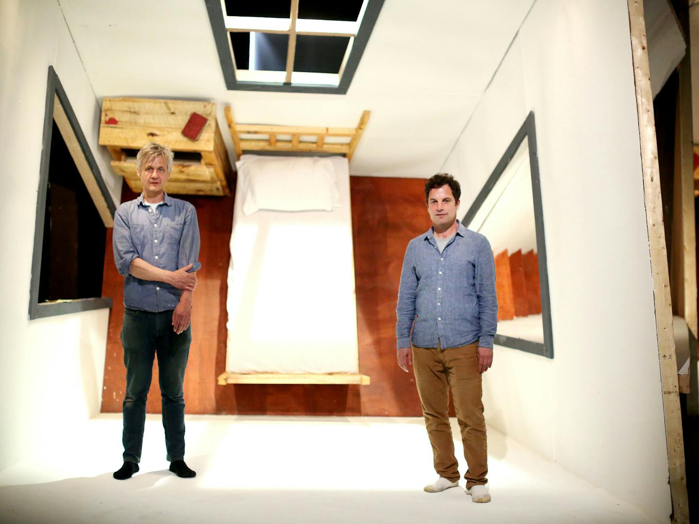 Visual artist Chris Larson, left, and composer Anthony Gatto in a topsy-turvy room that is part of the &#x201c;Wise Blood&#x201d; set.