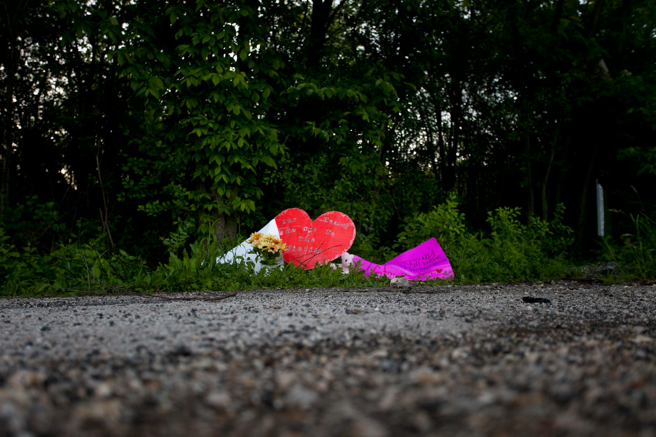 A memorial is left outside the woods where a 12-year-old girl was stabbed repeatedly by two of her classmates in Waukesha, Wis., June 5, 2014. The unfathomable moment of violence -- which the attackers attributed to their obsession with Slender Man, a macabre internet myth -- has deeply shaken parents and children alike in this upper-middle-class Milwaukee suburb. (Armando L. Sanchez/The New York Times)