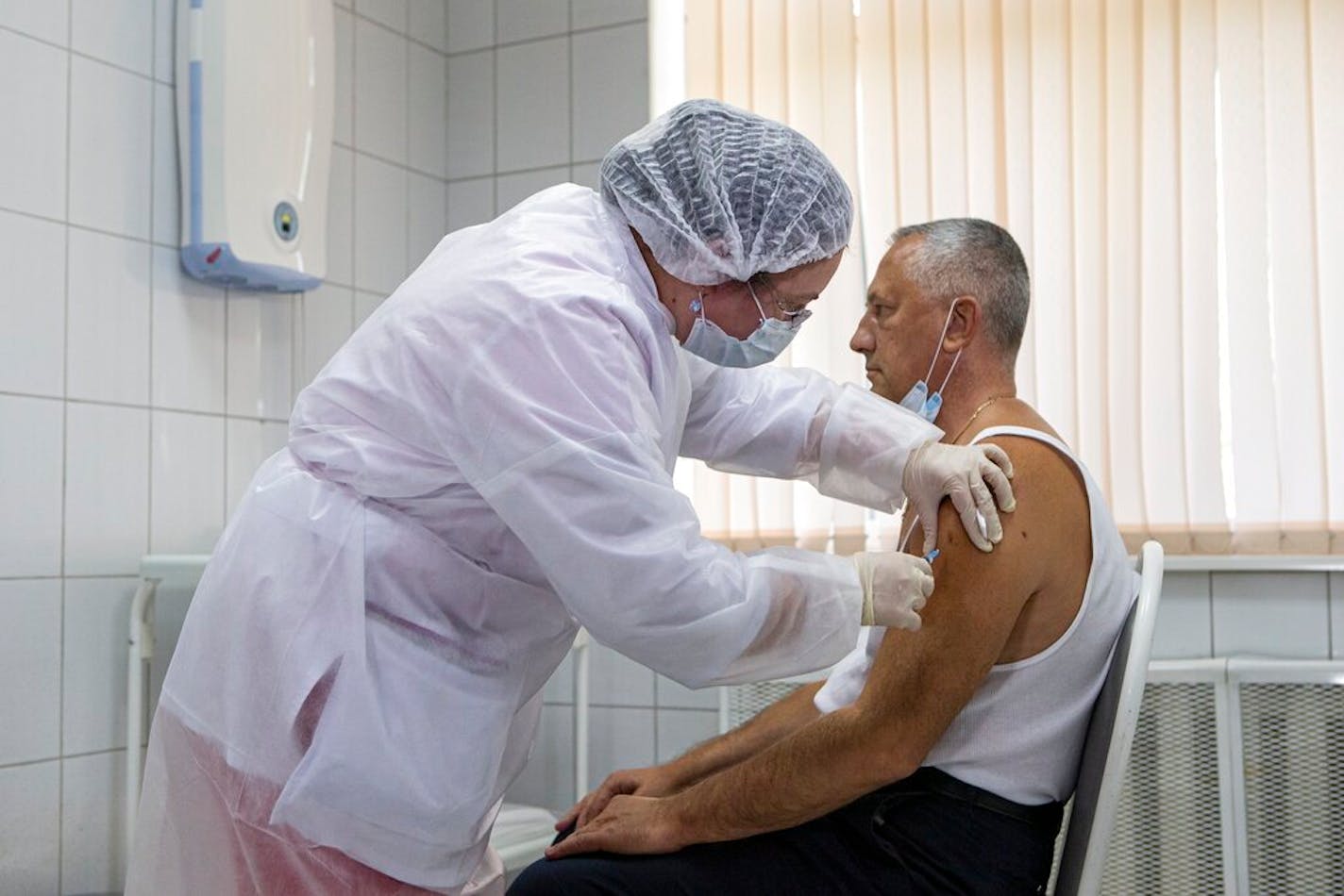 A Russian medical worker administered a shot of Russia's experimental Sputnik V coronavirus vaccine in Moscow on Sept. 15.