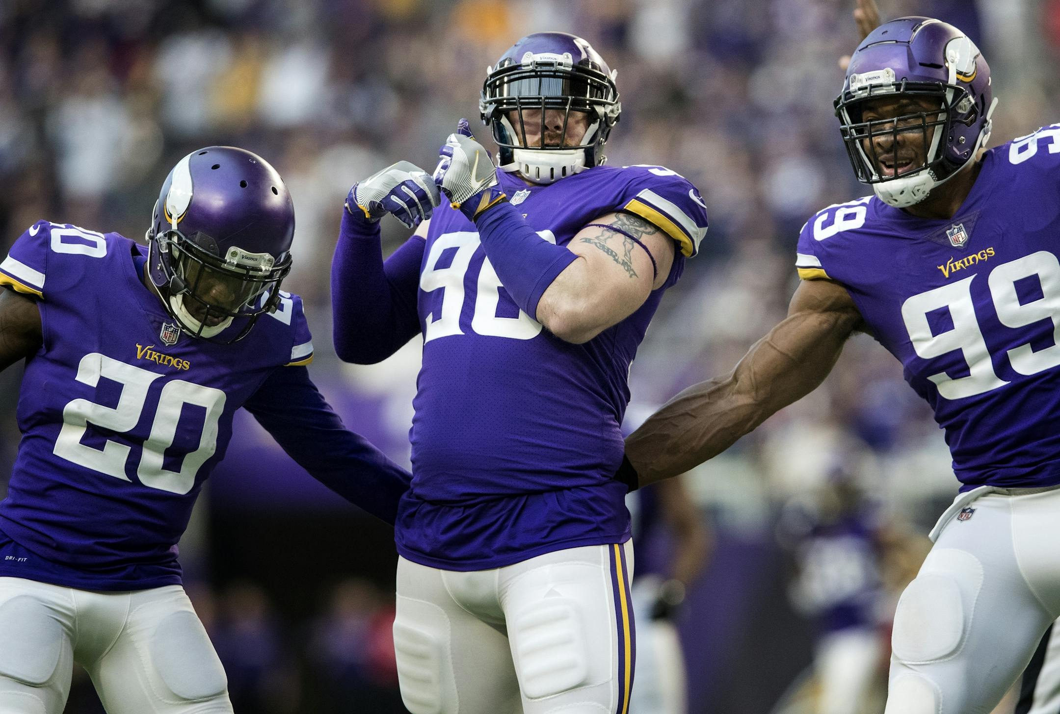 Brian Robison (96) celebrated after a sack with Mackenzie Alexander (20) and Danielle Hunter (99) in the third quarter.