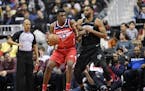 Washington Wizards center Thomas Bryant (13) dribbles the ball against Minnesota Timberwolves forward Keita Bates-Diop, right, during the first half o
