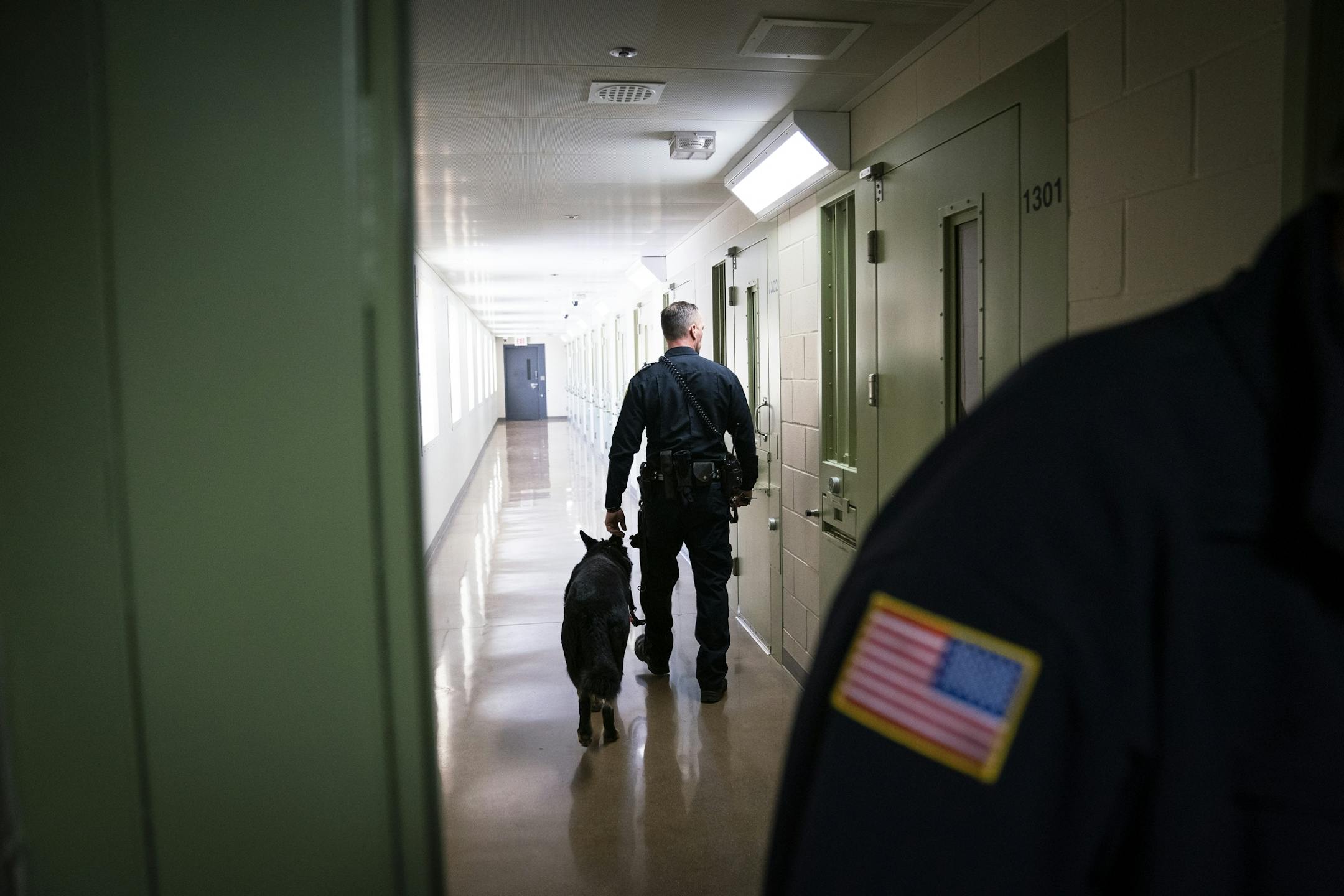A corrections officer with a dog walked down the hallway inside the segregation unit at Stillwater prison on Jan. 25.
