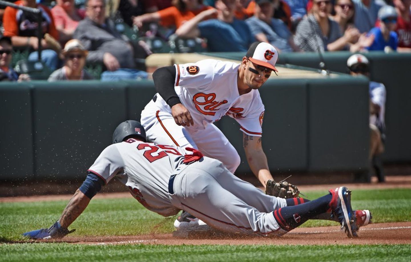 The Minnesota Twins' Byron Buxton, bottom, reached third base ahead of the tag by Baltimore Orioles' Rio Ruiz, top, after tagging up in the fourth inning on Sunday, April 21, 2019 at Oriole Park at Camden Yards in Baltimore, Md. Buxton later scored, the eventual winning run, on a sacrifice fly by Willians Astudillo. The Twins defeated the Orioles by score of 4-3.