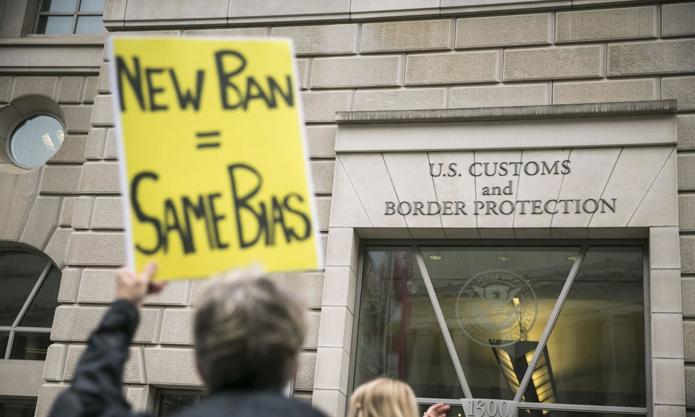 FILE -- Protesters demonstrate against President Donald Trump&#x2019;s revised travel ban, outside the U.S. Customs and Border Protection headquarters in Washington, March 7, 2017. A federal appeals court in Richmond, Va. refused to reinstate the ban on May 25, saying it discriminated on the basis of religion; the case is likely to go to the Supreme Court. (Al Drago/The New York Times)