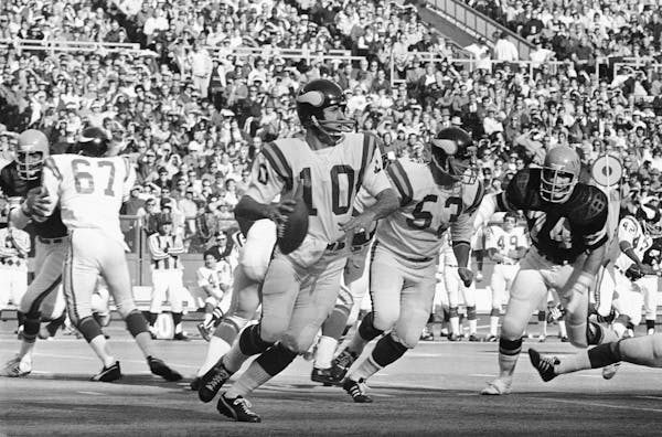 Vikings quarterback Fran Tarkenton (10) has trouble getting rid of the ball in first-half action against the Bengals, Dec. 2, 1973 in Cincinnati