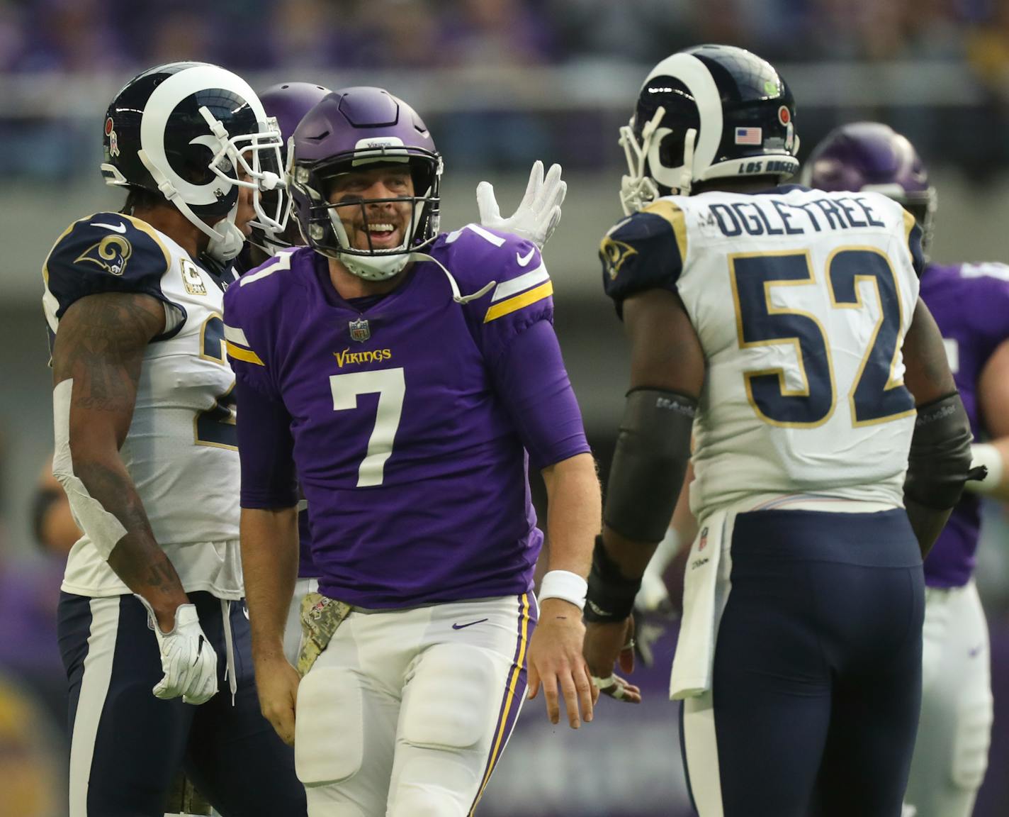 Minnesota Vikings quarterback Case Keenum (7) grinned at Los Angeles Rams inside linebacker Alec Ogletree (52) after he was stopped by him after scrambling for a 14 yard gain in the second quarter.