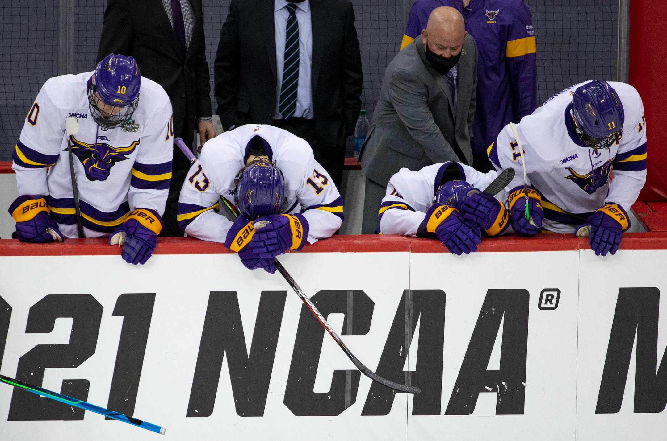 Minnesota State Mankato players hung their heads in disappointment after losing 5-4 in the men's hockey national semifinal to St. Cloud State.