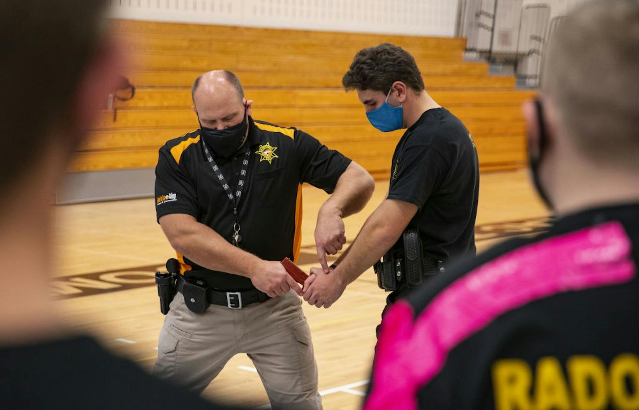(From left) Law Enforcement Coordinator Joel Olejnicak demonstrated how to break someone's grip on the barrel of a gun with Dylan Crist, a law enforcement trainee. Defensive tactics class took place in the gymnasium at Fond Du Lac Tribal and Community College in Cloquet, Minn. on Tuesday November 17, 2020.