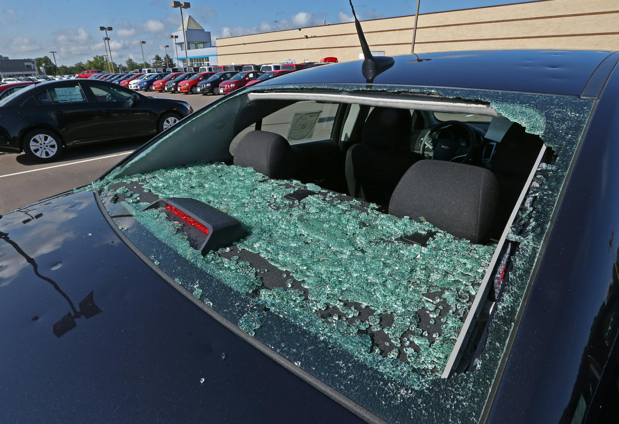 The rear window was shattered on a new Chevy Cruze at Suburban Chevy, where every single car, (around 1000) were hail damaged at the Chevy store and nearby Metropolitan Ford in Eden Praire after yesterday's severe storms.] Bruce Bisping/Star Tribune bbisping@startribune.com