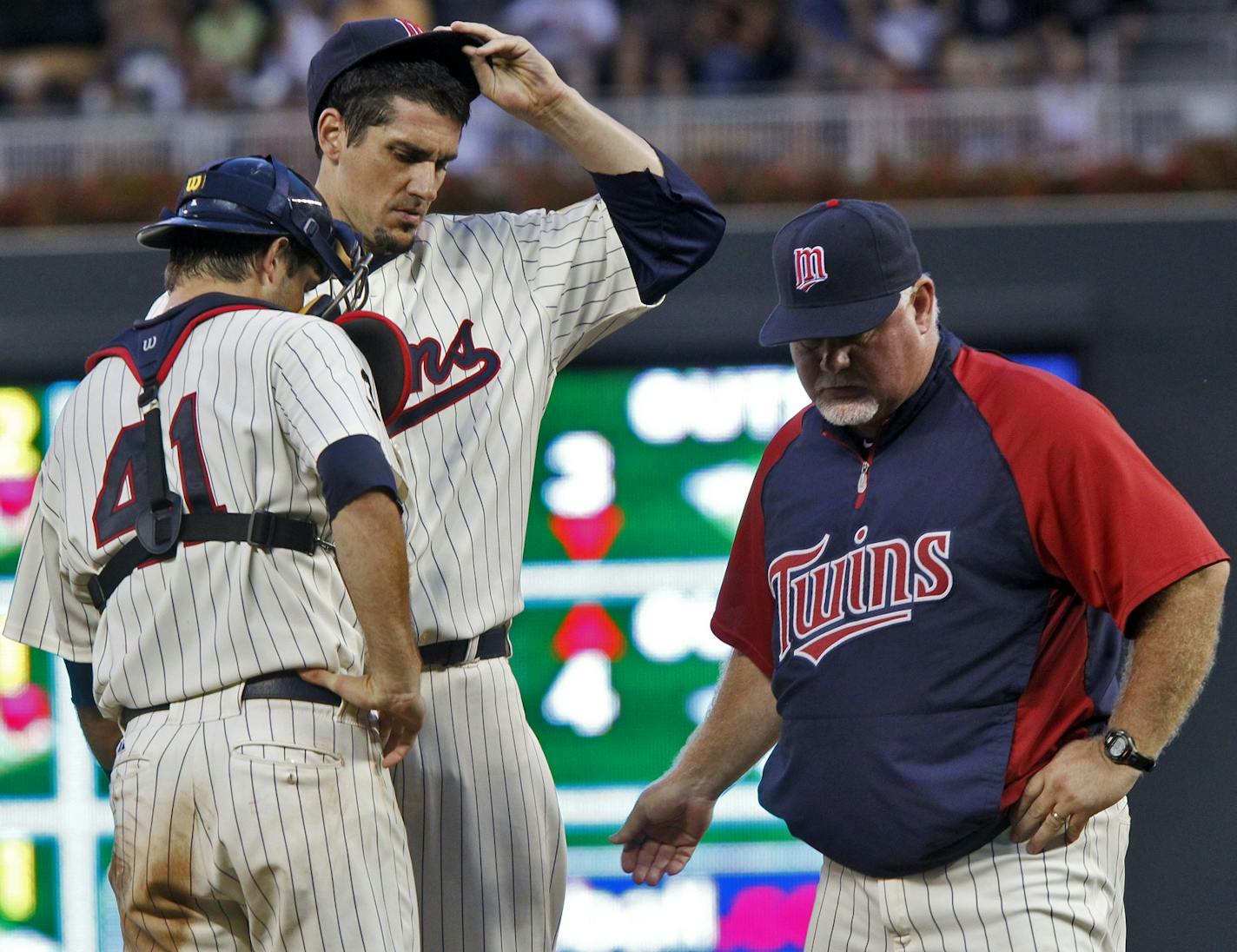 There was little joy on the mound Saturday as Twins manager Ron Gardenhire removed starting pitcher Carl Pavano, center, as catcher Drew Butera stood by.