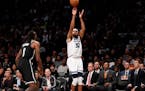 Brooklyn Nets center DeAndre Jordan (6) watches as Minnesota Timberwolves center Karl-Anthony Towns (32) releases a 3-point shot during the first half