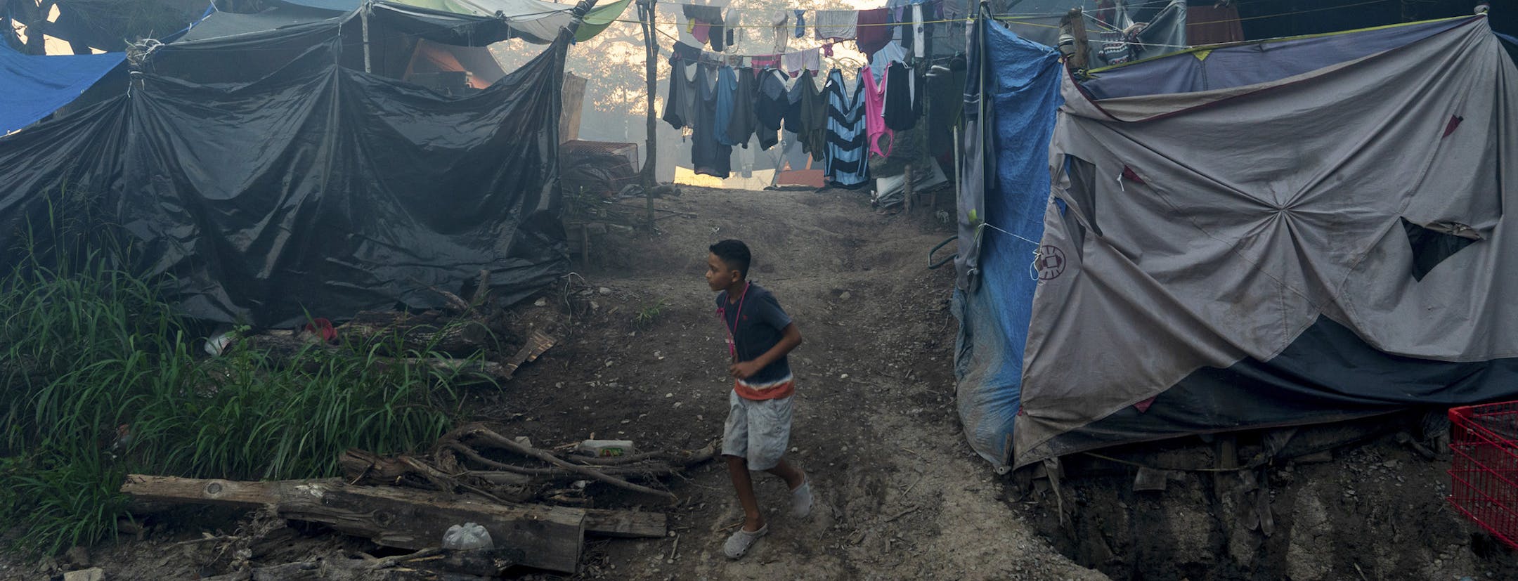 FILE -- A migrant camp near the U.S. border in Matamoros, Mexico, Aug. 5, 2020. U.S. authorities improperly expelled Central American children in violation of international agreements. Families scrambled to learn how they had ended up back across the border. (Ilana Panich-Linsman/The New York Times)