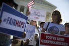 Demonstrators outside the U.S. Supreme Court building as justices heard arguments in a key gerrymandering case, on Capitol Hill in Washington, Oct. 3,