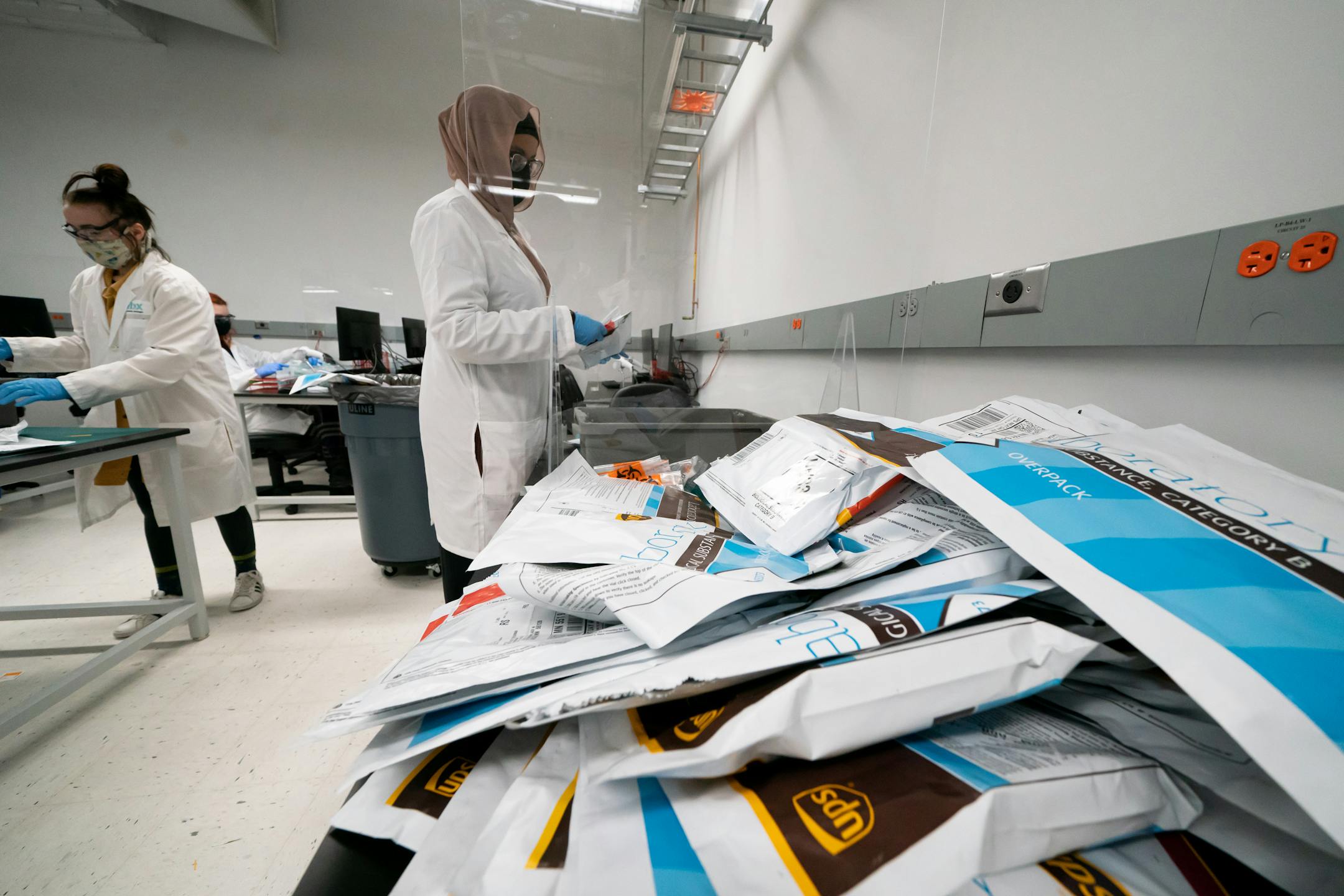 Asma Mohamed removed samples from their packaging in the IBX processing area.