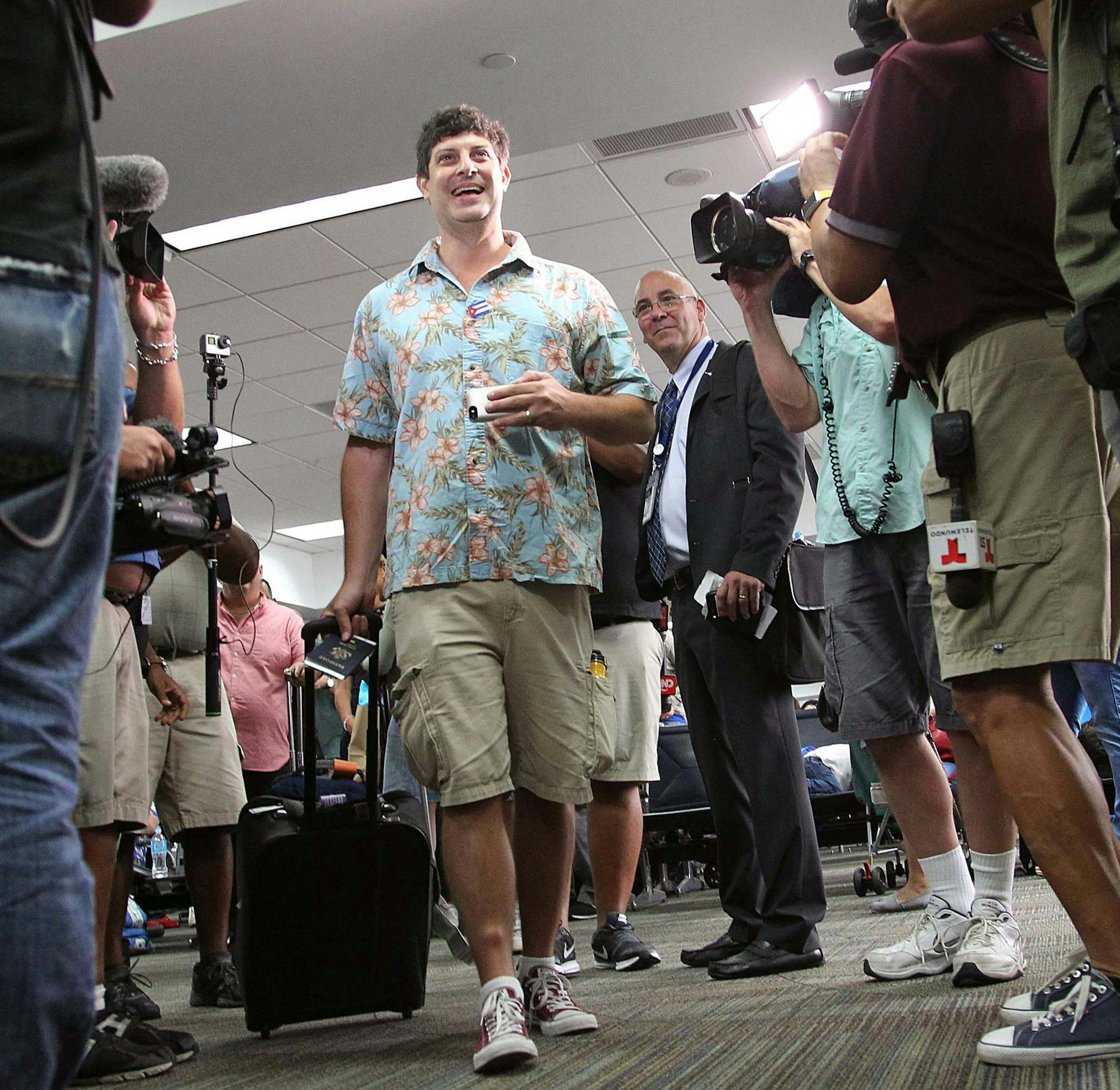New York City resident Seth Miller, left, walks up to boarding agent as he becomes the first passenger to board JetBlue Flight 387 for Cuba on Aug. 31, 2016 in Fort Lauderdale, Fla. On Wednesday JetBlue became the first U.S. airline to initiate commercial flights with Cuba in more than 50 years, kicking off with a flight from Fort Lauderdale-Hollywood International Airport to Santa Clara, Cuba. (Carl Juste/Miami Herald/TNS)