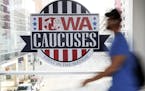 A pedestrian walks past a sign for the Iowa Caucuses on a downtown skywalk, Tuesday, Feb. 4, 2020, in Des Moines, Iowa. (AP Photo/Charlie Neibergall)