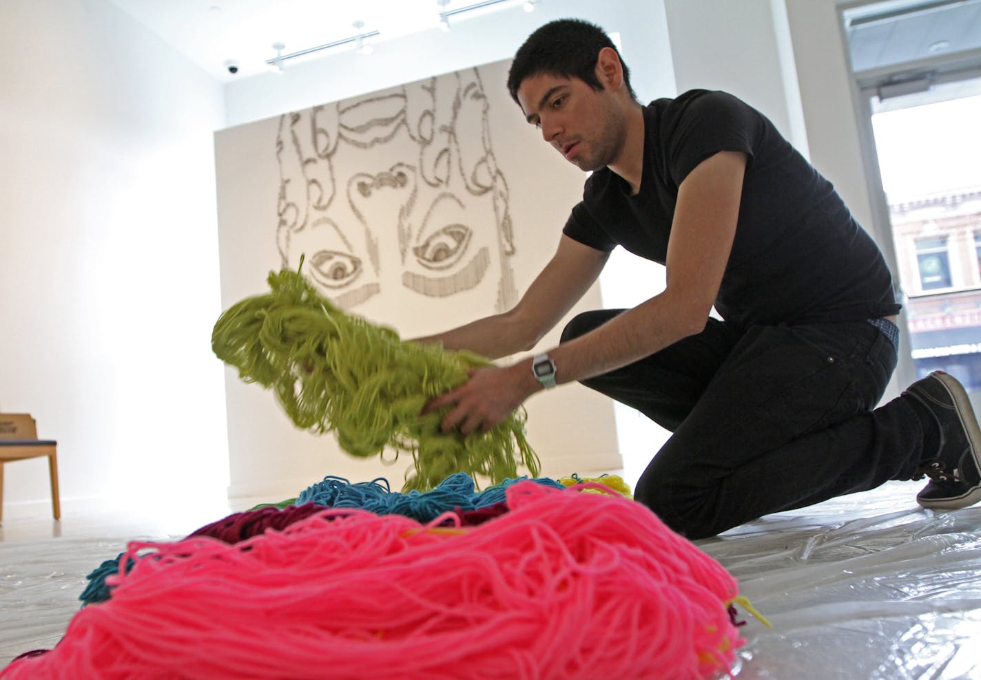 Graffiti artist turned yarn maestro HOTTEA, aka Eric Rieger, sorted through yarn, on 5/8/13, as he installed his first big solo show at BURNET Gallery in downtown Minneapolis, a "collective self-portrait" he calls it. Story about this pop phenom and MCAD grad.]