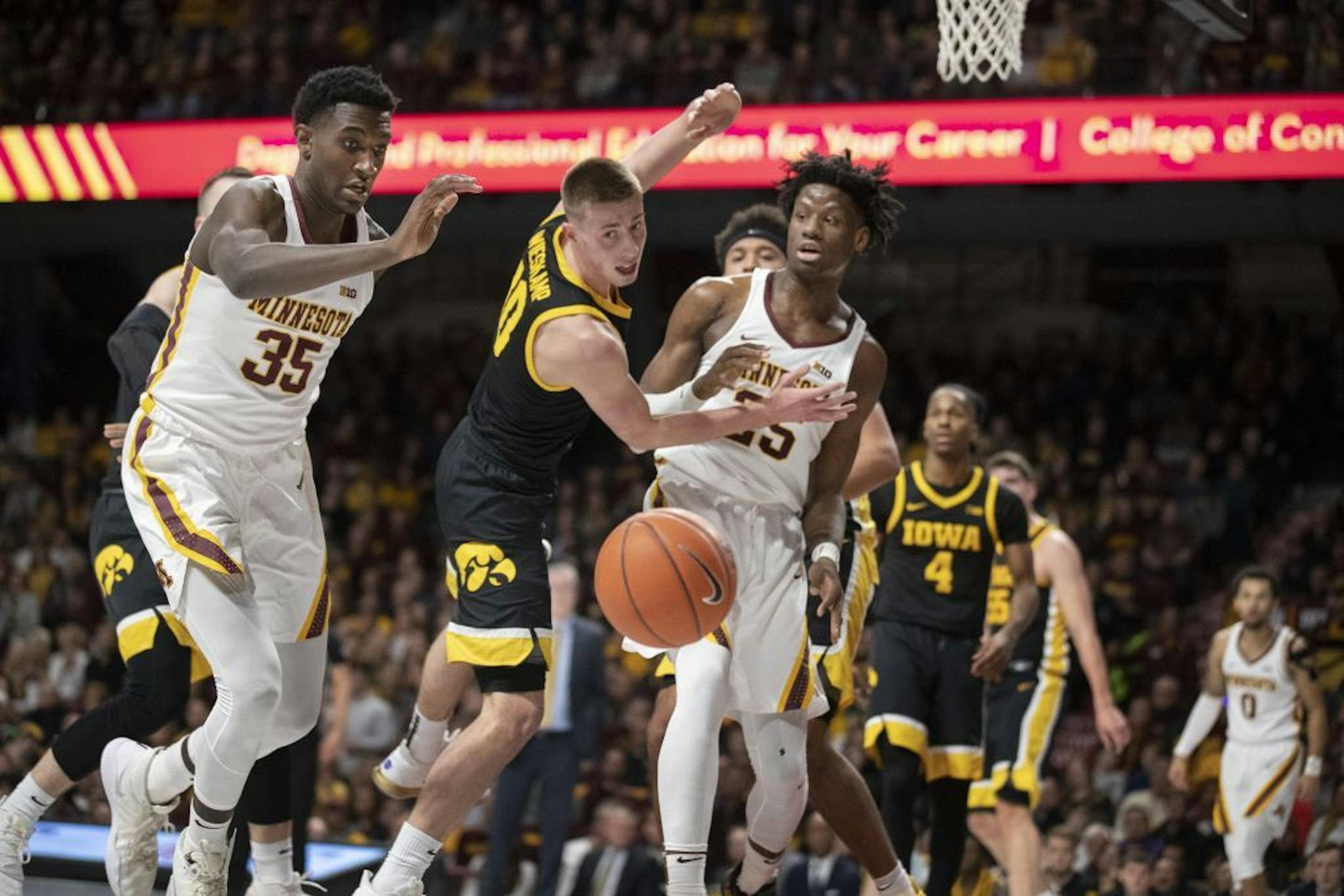 Isaiah Ihnen (35) and Iowa Hawkeyes guard Connor McCaffery (30) chased a loose ball in the first half .