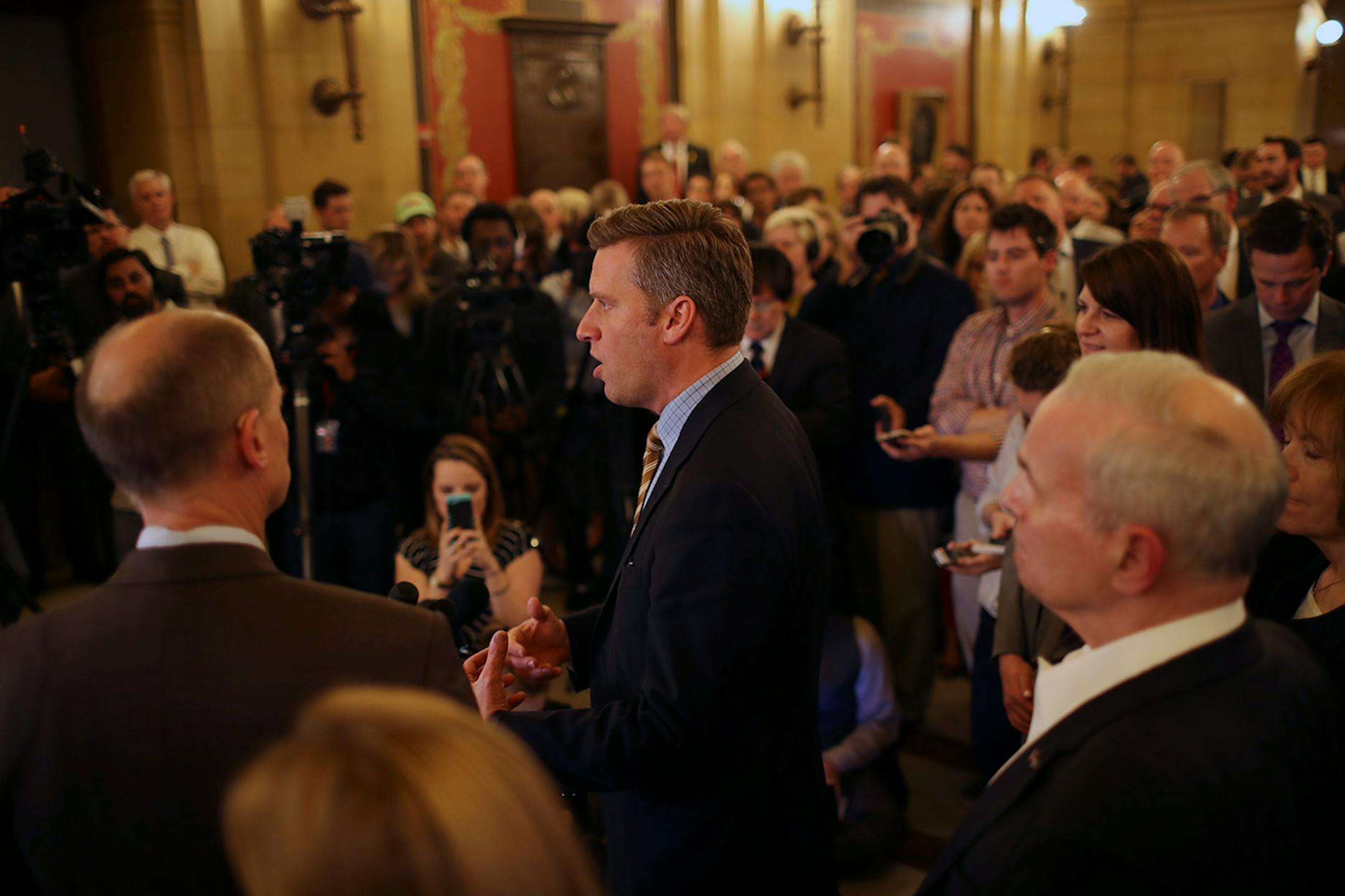 Rep. Kurt Daudt, Speaker of the House, center, after he and the leadership announced that an agreement had been reached between them and the Governor, right, to convene a special session at 12:01 a.m. Tuesday to take on the outstanding budget bills and the tax bill. With Daudt was Senator Paul Gazelka, Senate Majority Leader, left, and Lt. Governor Tina Smith, right.