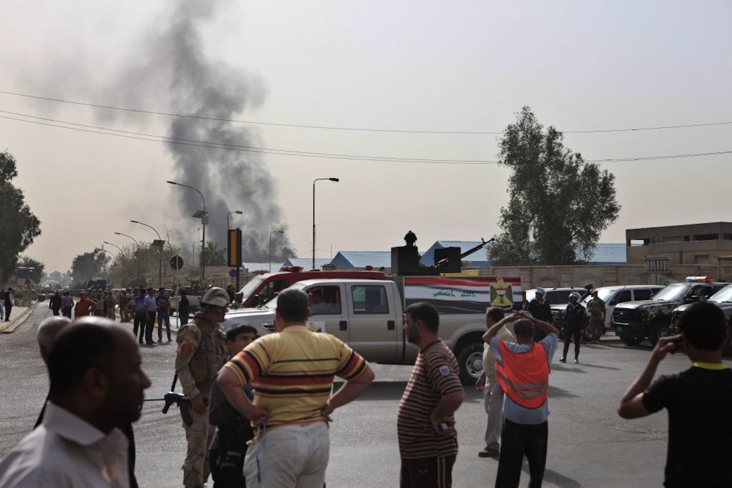 Black smoke from a car bomb attack is seen in Baghdad, Iraq, Thursday, March, 14, 2013. A string of explosions tore through central Baghdad within minutes of each other on Thursday, followed by what appeared to be a coordinated assault by gunmen who battled security forces in the Iraqi capital, according to officials. Authorities say more than a dozen have been killed.