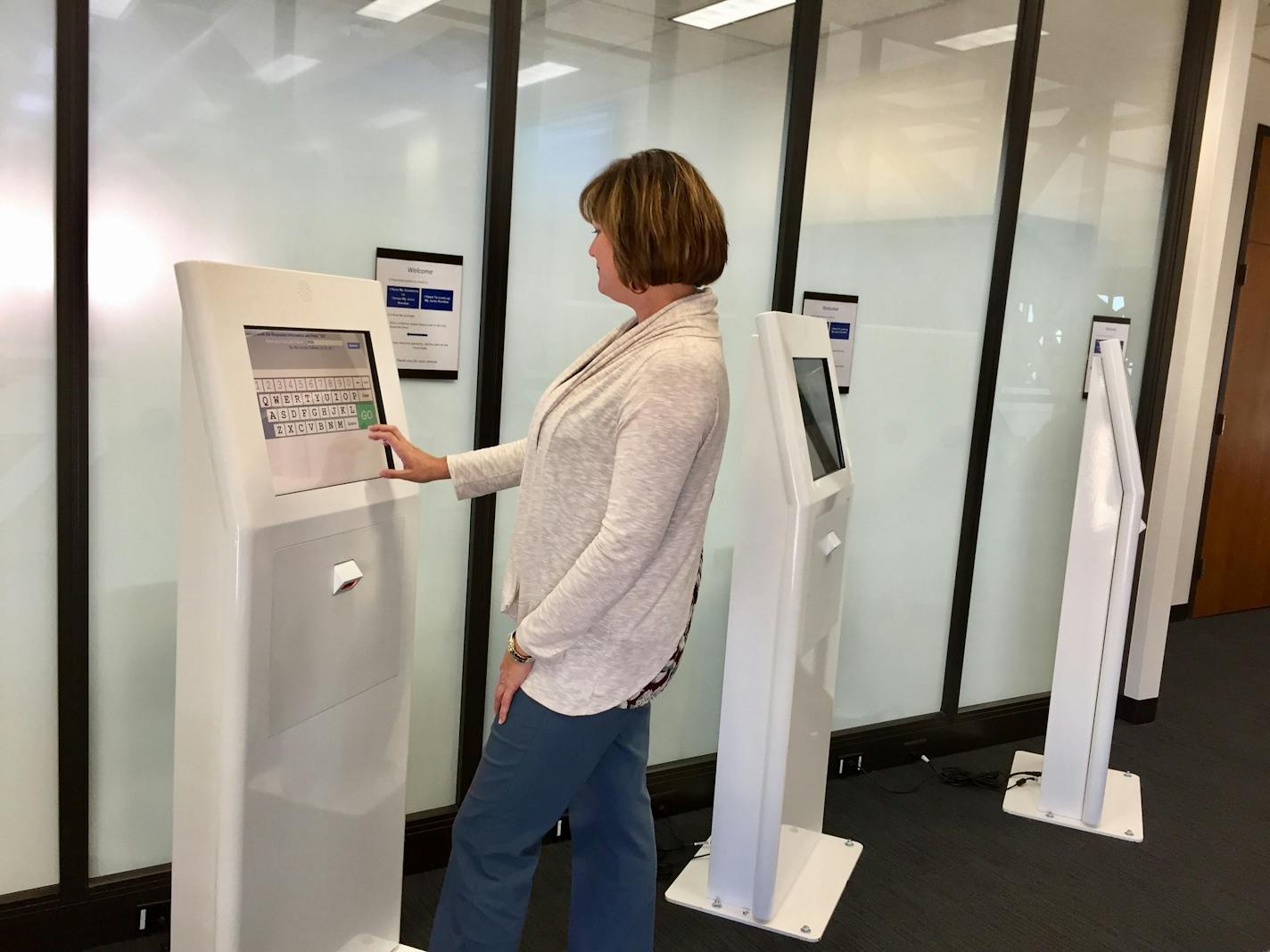 Hennepin County District Court Administrator Kate Fogarty tests out new kiosks outside the newly renovated jury assembly room at the top of the Hennepin County Government Center on Feb. 17, 2017. The kiosks allow jurors to check in electronically, speeding up the process and allowing court proceedings to start on time.