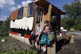 William Gratz left and Claire Boucher sat on their houseboat at the Minneapolis impound lot on Thursday afternoon. The young college students built their houseboat/ raft with hope of sailing down the Mississippi river to New Orleans.