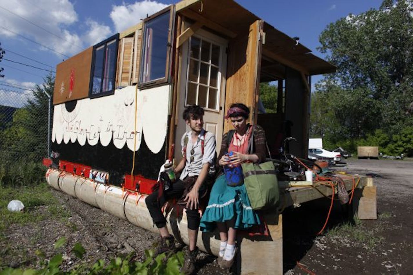 William Gratz left and Claire Boucher sat on their houseboat at the Minneapolis impound lot on Thursday afternoon. The young college students built their houseboat/ raft with hope of sailing down the Mississippi river to New Orleans.