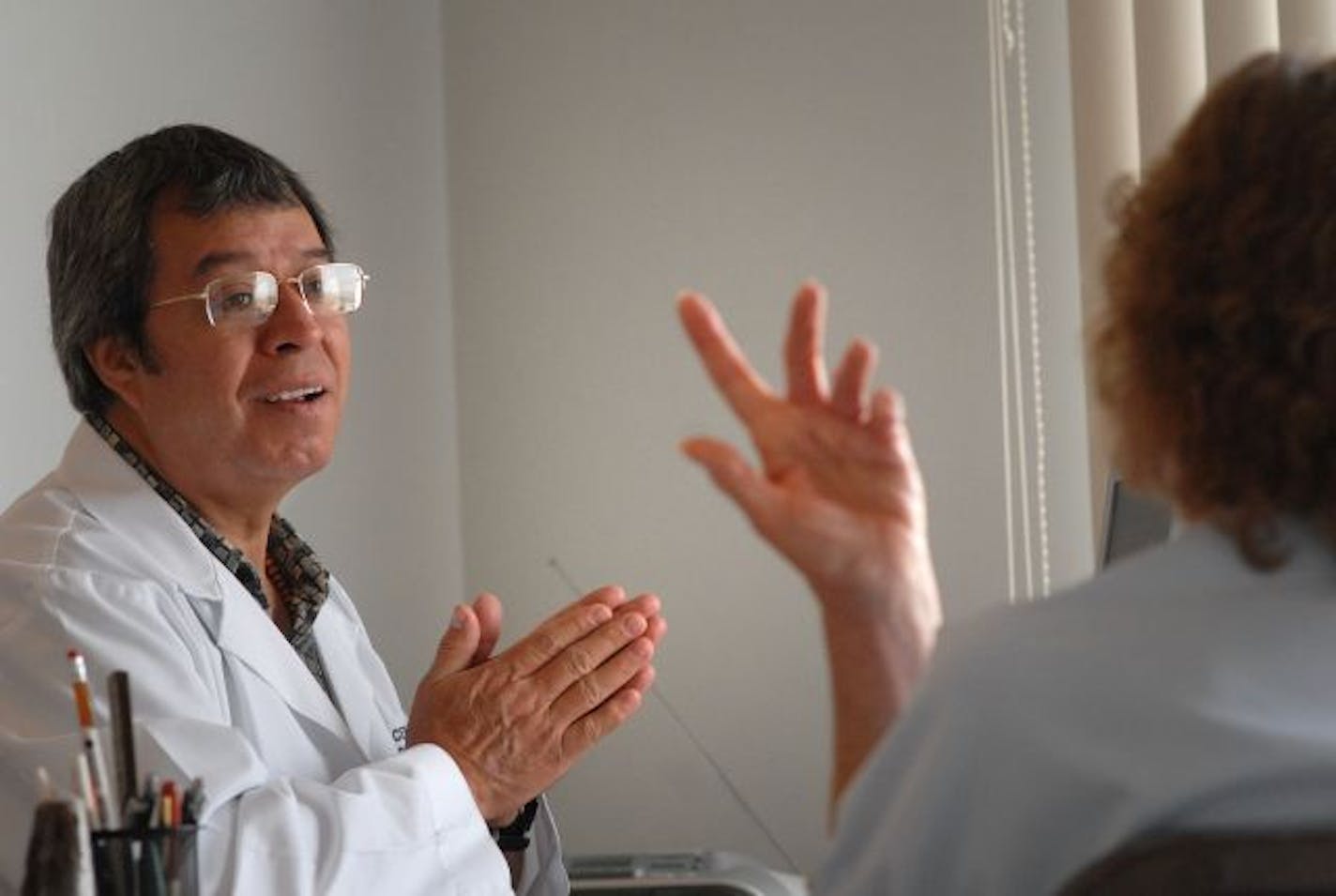 Doctor Elias Gutierrez listens during a check up to patient Loretta Lush, 64, who is receiving treatment for malignant melanoma at Bio Medical Center, an alternative cancer treatment facility in Tijuana, Mexico. Lush lives in Kansas City, Missouri.