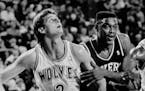 November 10, 1989 Can I Play too? -- Philadelphia 76er's Rick Mahorn, center tries to edge in between Minnesota Timberwolves Scott Roth (3) and Tony c