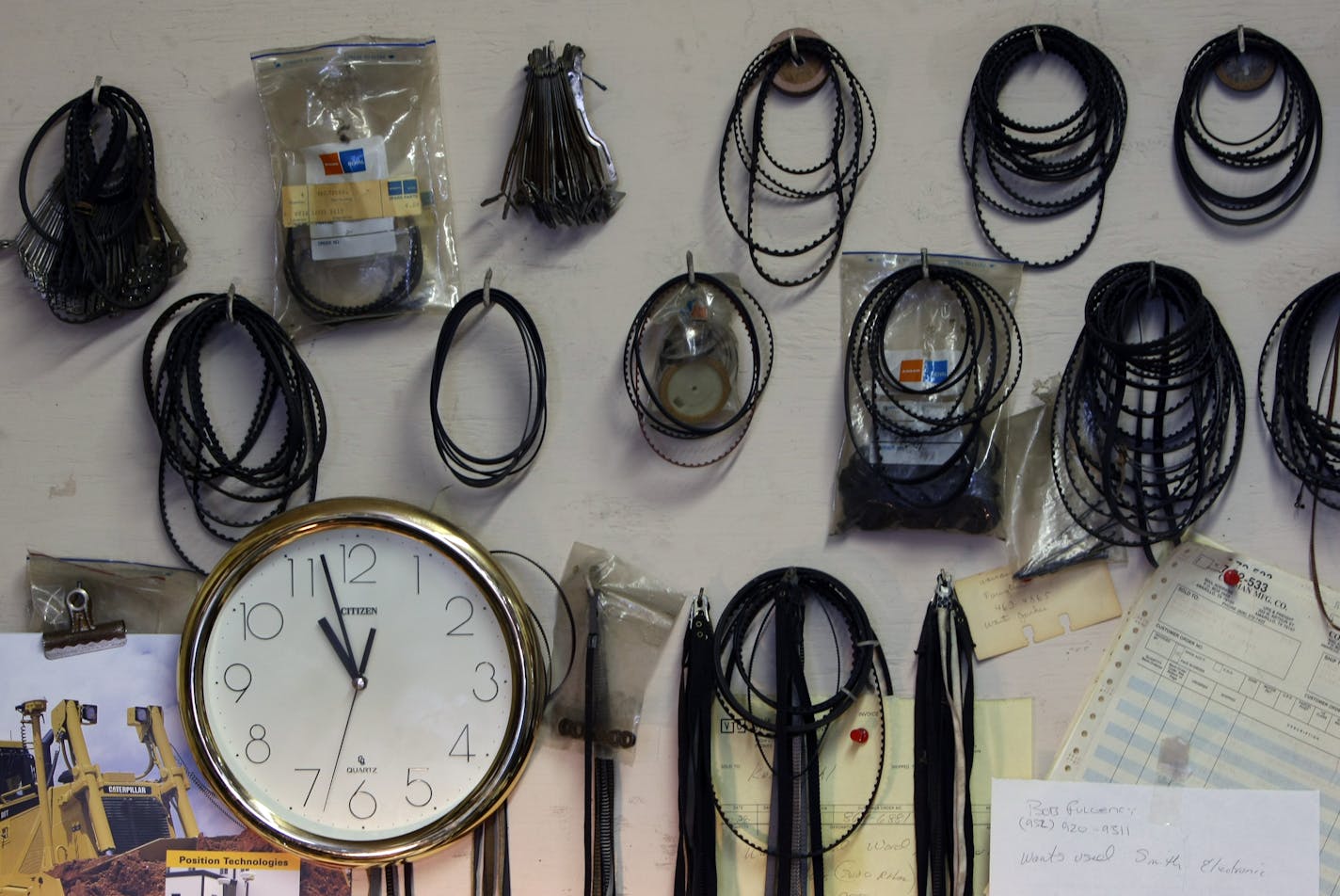 Typewriter belts of all sizes hang ready on the wall.