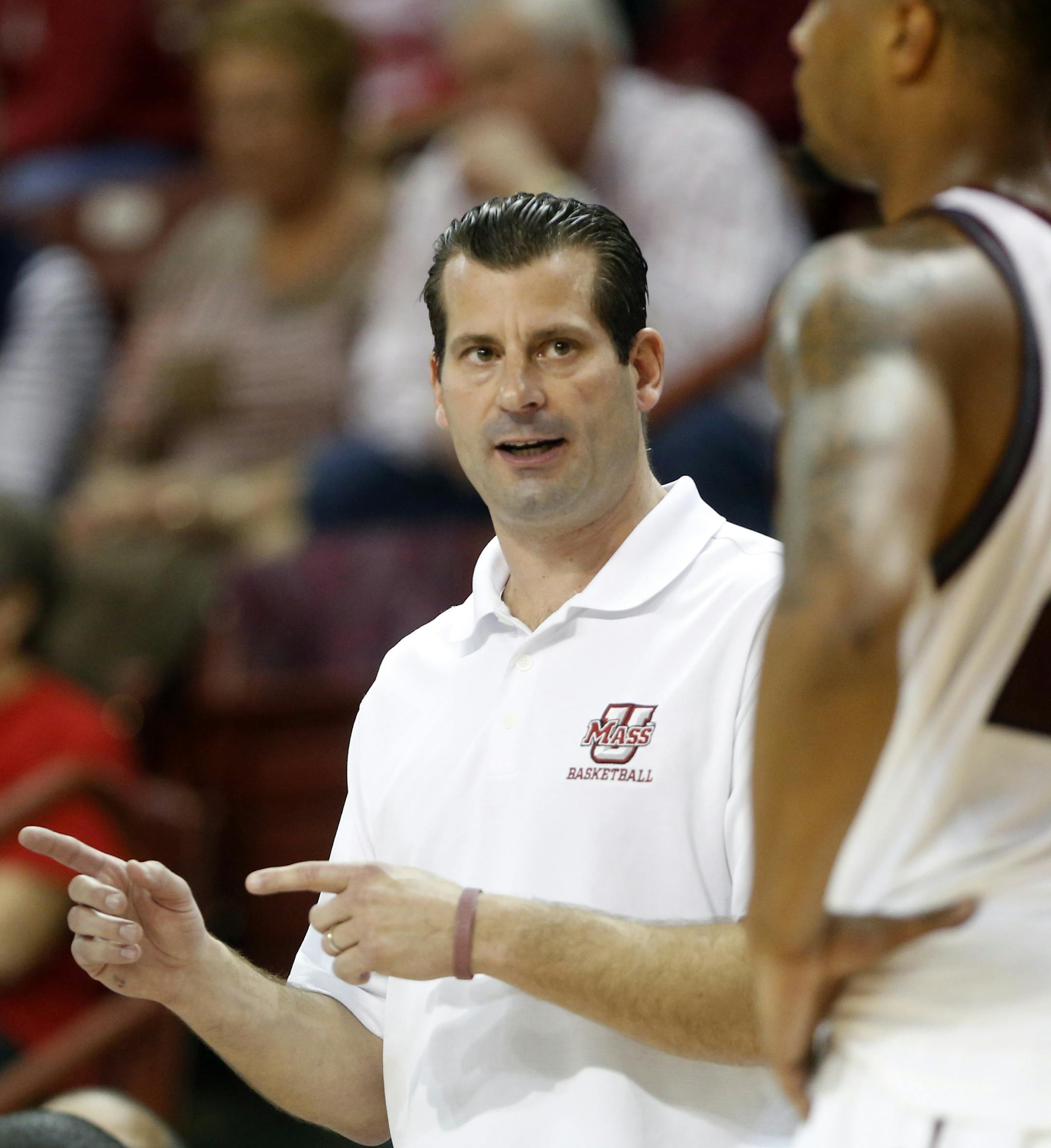 Massachusetts head coach Derek Kellogg talks to player Sampson Carter in the second half of a game against Nebraska at the Charleston Classic NCAA college basketball tournament in Charleston, S.C., Thursday, Nov. 21, 2013. (AP Photo/Mic Smith) ORG XMIT: SCMS106