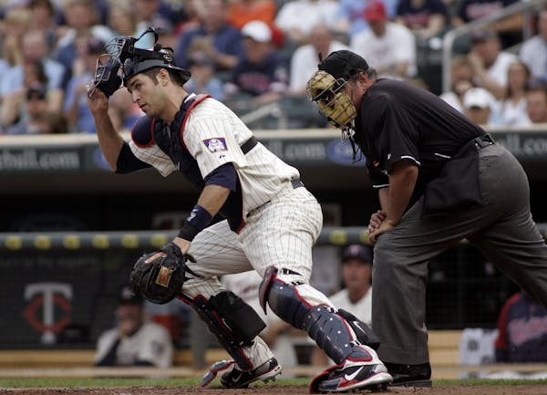 Twins Joe Mauer kept his eyes up as he chased down a low pitch from Brian Duesing in the first inning