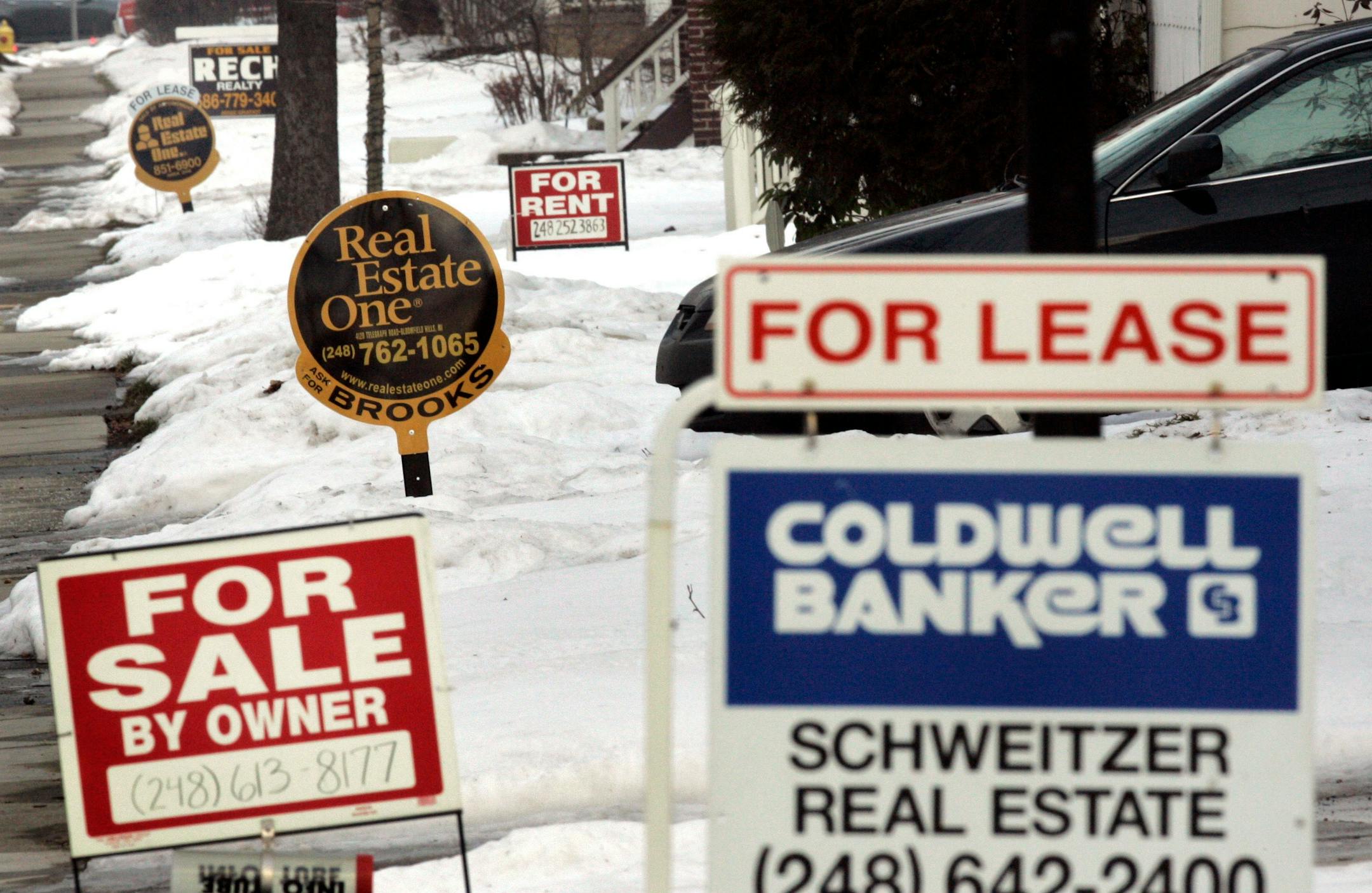 Real estate agents' signs line a Birmingham, Mich., street in this Feb. 21, 2007 file photo. Battered by a declining manufacturing base, stagnant population growth and low demand for housing, Michigan and Ohio rank No. 1 and 2 on mortgage finance company Fannie Mae's list of states with the largest credit losses through Sept. 30.