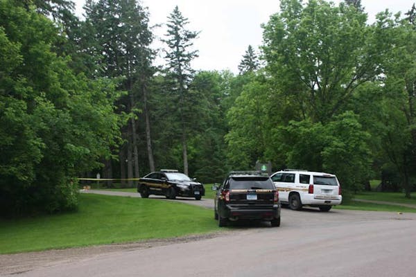 Crow Springs County Park is closed, with caution tape and Wright County Sheriff's Office vehicles blocking the entrance, as officers investigate the c