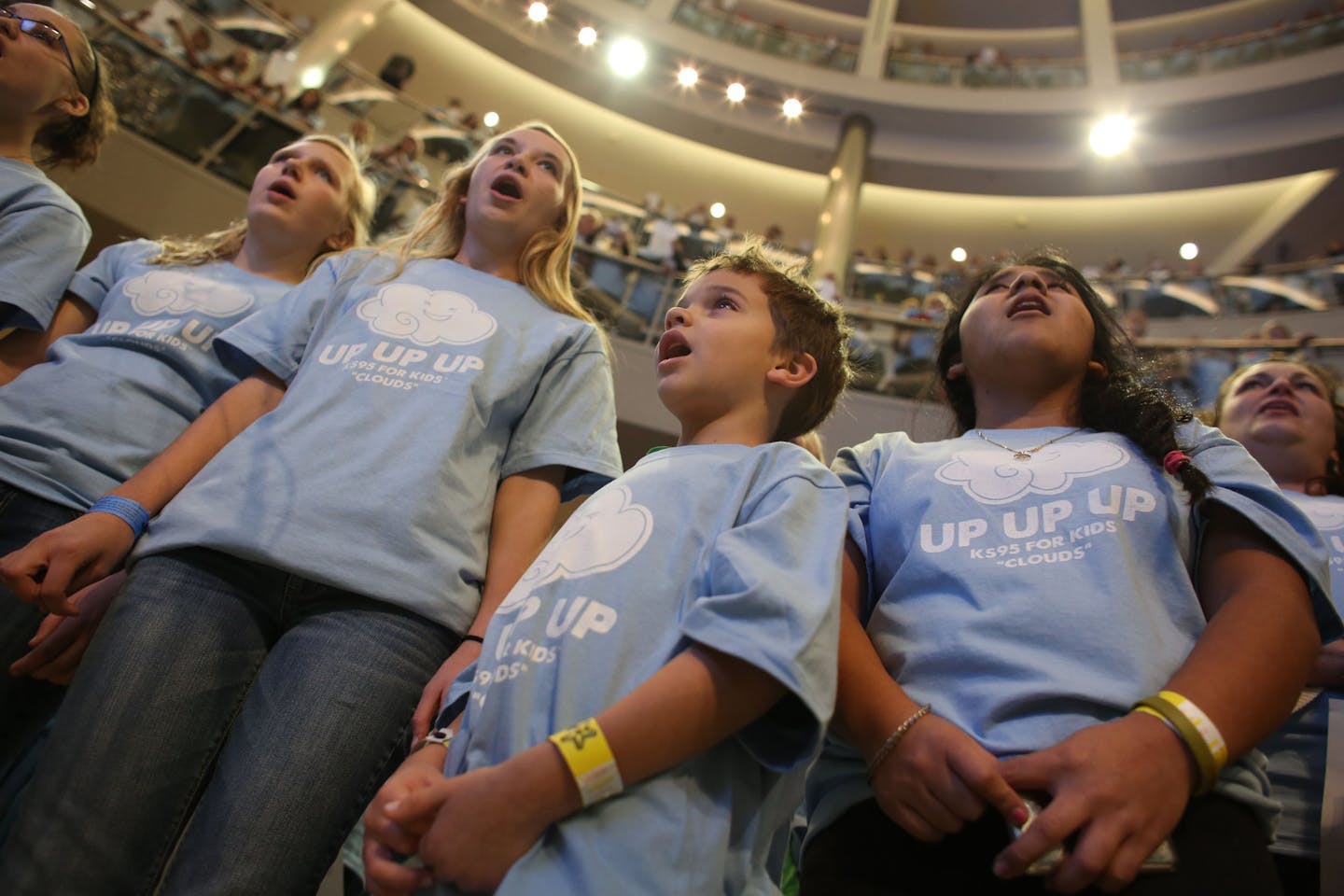 Jackson Henkenius, 6, of Arden Hills stood next to students from Mahtomedi High School and sang along in the rotunda at the Mall of America in Bloomington, Thursday, December 3, 2013. More than 3,500 people registered to participate in the largest "Clouds" Choir in honor of Zach Sobiech, a teen from Lakeland, Minn., who passed away from osteosarcoma in May this year ] (KYNDELL HARKNESS/STAR TRIBUNE) kyndell.harkness@startribune.com