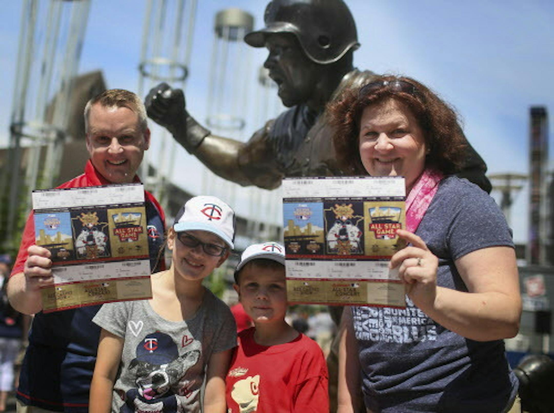 Blake Fry and his wife Michele, hold on to their coveted All-Star Game tickets before heading to watch the Twins take on the New York Yankees with their children Liam, 7, and Abby, 11, Friday, July 4, 2014, at Target Field in Minneapolis, MN. The Fry family is from River Falls, WI. Blake Fry, who is a partial season ticket holder, has been to about 700 Major League baseball games but this will be his first All-Star game.] (DAVID JOLES/STARTRIBUNE) djoles@startribune Tickets for the Major League