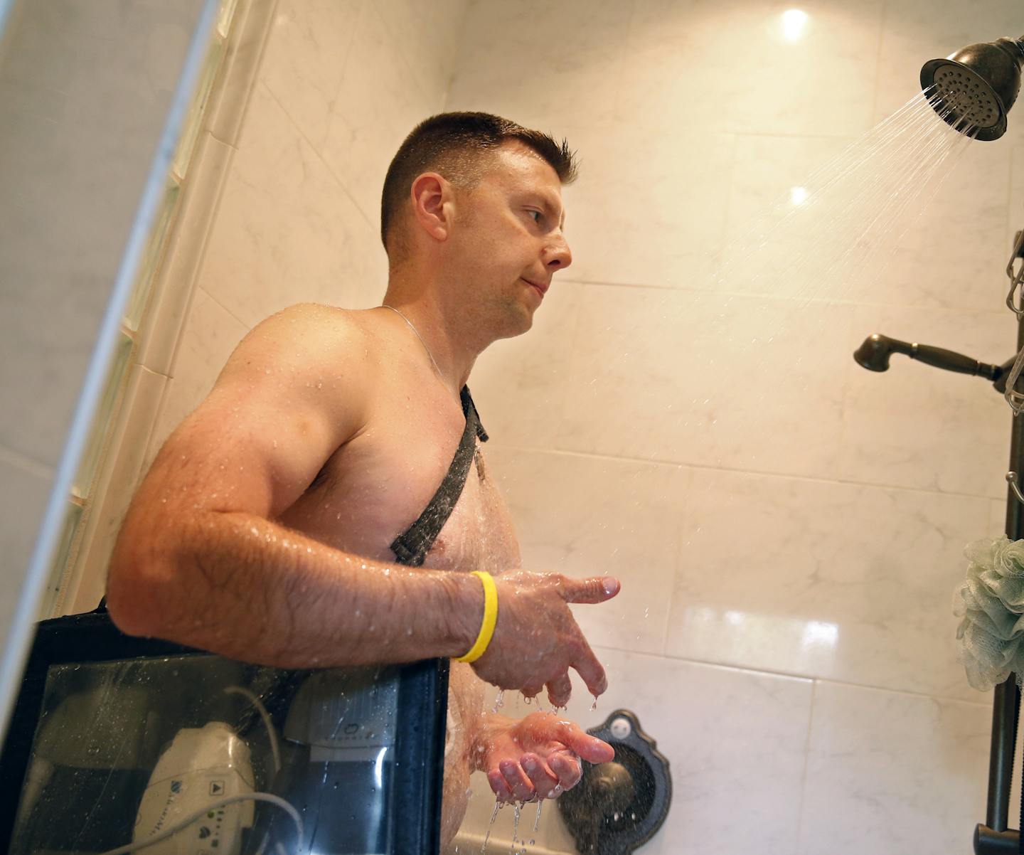 At his home in Plymouth, Peter Quimby must waterproof the batteries and control unit that run his left ventricular assist device, LVAD while he showers. His heart is at 5% capacity and he is on a waiting list for a heart transplant. ] tsong-taataarii@startribune.com