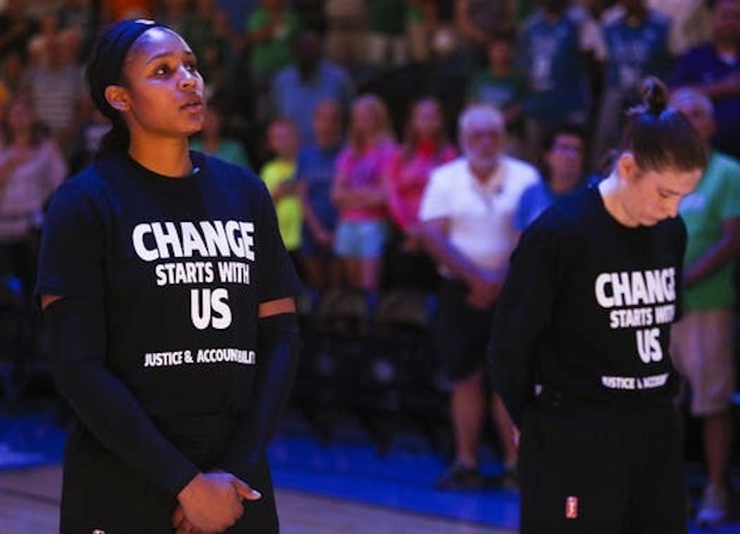 Maya Moore, left, and Lindsay Whalen observed a moment of silence in honor of Philando Castile in 2016.