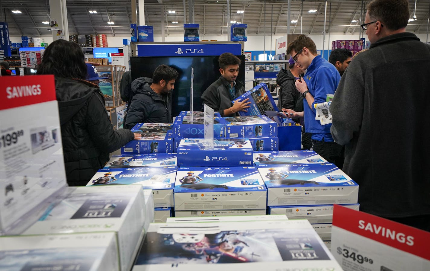 Shoppers looked for deals on PS4 and Xbox at the Best Buy Richfield Best Buy store on Thanksgiving. The holiday electronics sales boom is expected to continue this year. (GLEN STUBBE/Star Tribune)