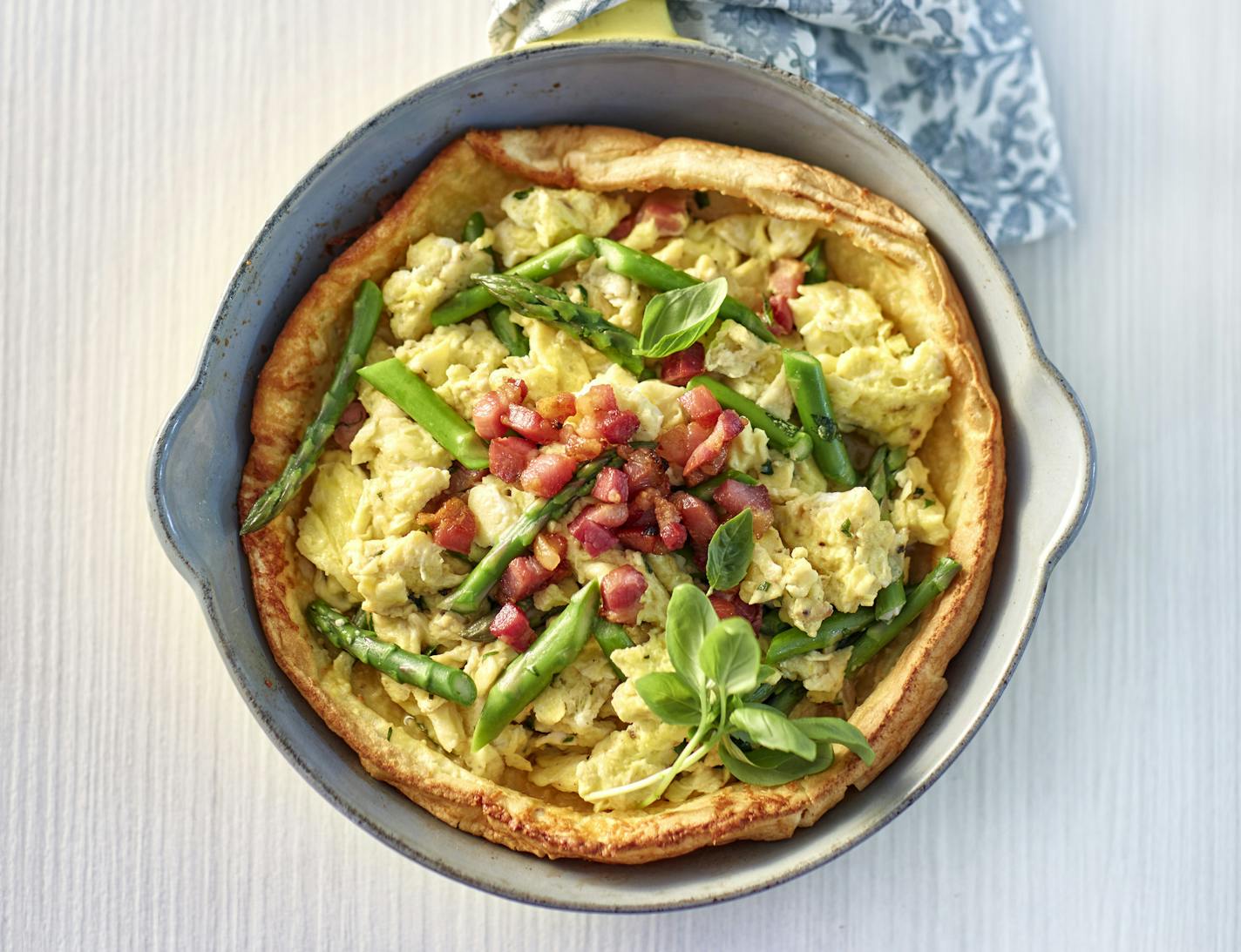 Dennis Becker Asparagus Basil Scrambled Eggs in Parmesan Dutch Baby With Crispy Pancetta.