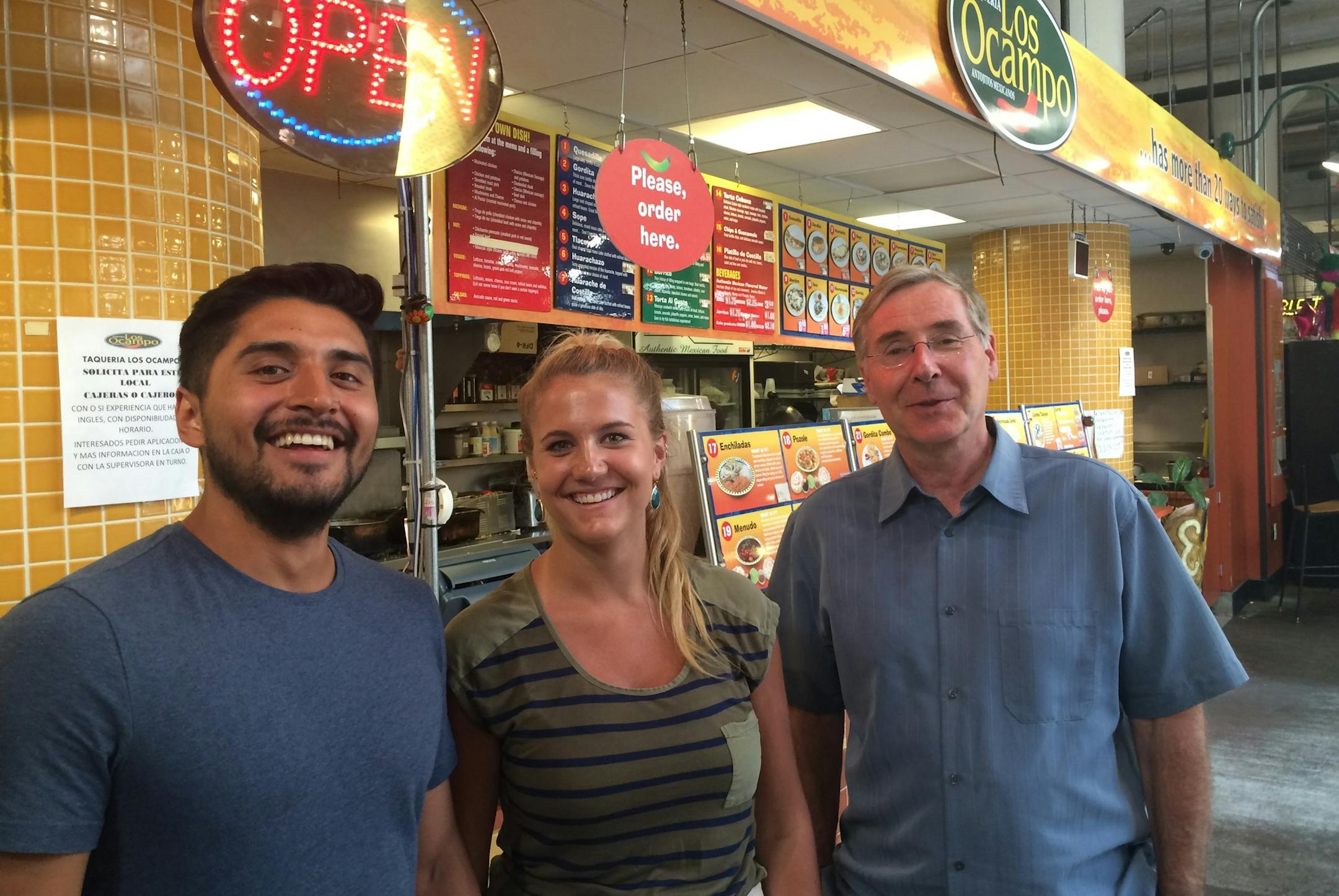 Julian Ocampo Zagel, of family-owned Los Ocampo restaurants; Kirsten Lande, a Midtown Global Market (MGM) customer; and Mihailo "Mike" Temali, the 30-plus year executive director of Neighborhood Development Center, part-owner of the MGM, and which trains entrepreneurs and helps starts businesses in hard-pressed Twin Cities neighborhoods. Los Ocampo, started by Mexican immigrants, has expanded to several locations.
