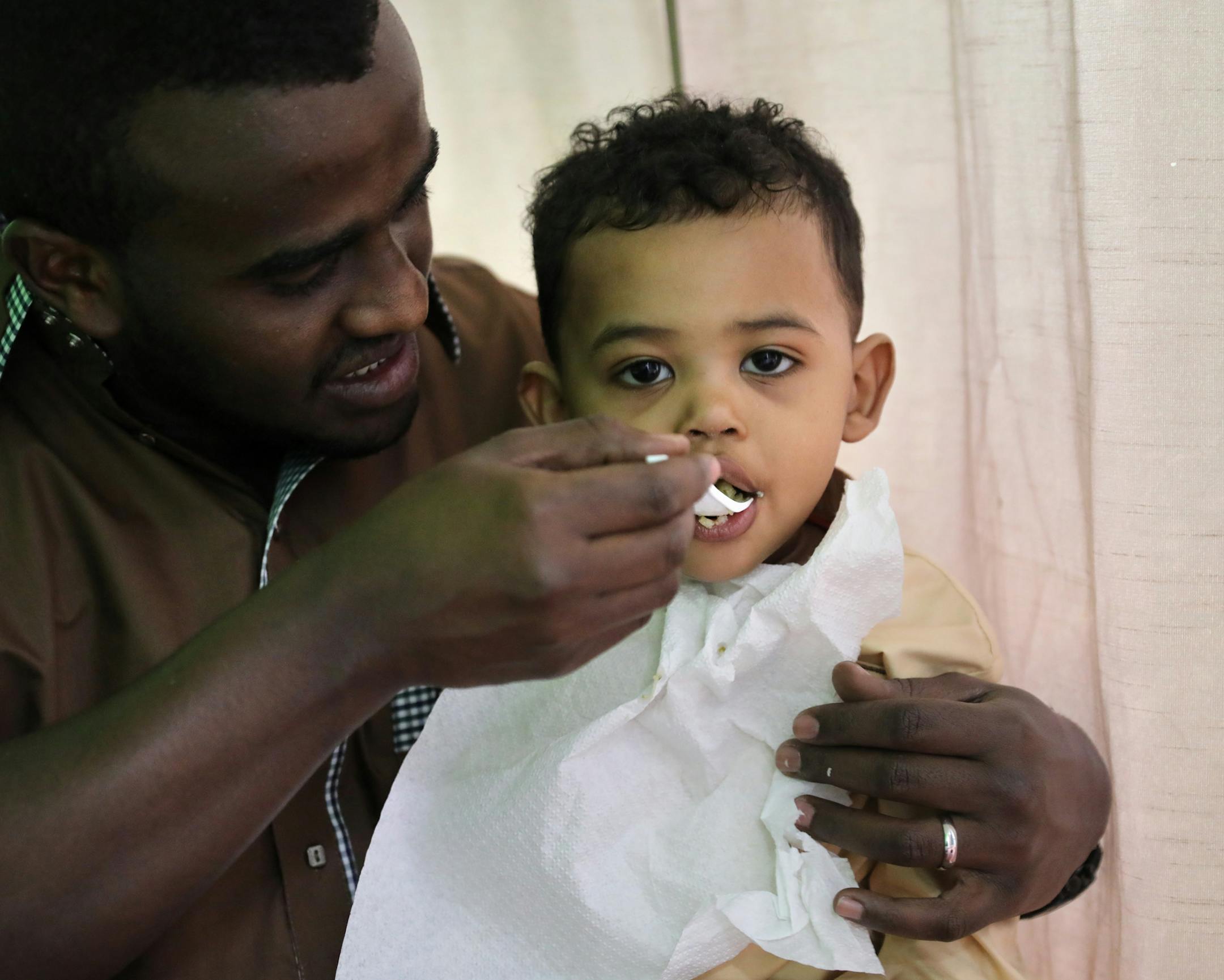 Abdifatah Adan feeds his two-year-old nephew Mutasim Ali during the " Dine out for Somalia" fund raiser Friday afternoon. Restaurants and coffee shops participating in Friday's Dine Out for Somalia will donate half of their sales to the famine in Somalia. ] BRIAN PETERSON ï brian.peterson@startribune.com
Minneapolis, MN 04/07/2017