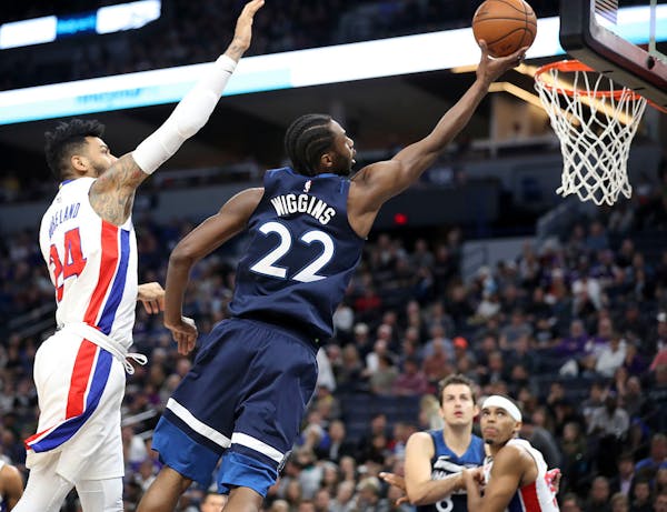 Minnesota Timberwolves forward Andrew Wiggins (22) makes a shot past Detroit Pistons forward Eric Moreland (24) during the first half.