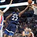 Minnesota Timberwolves forward Andrew Wiggins (22) makes a shot past Detroit Pistons forward Eric Moreland (24) during the first half.