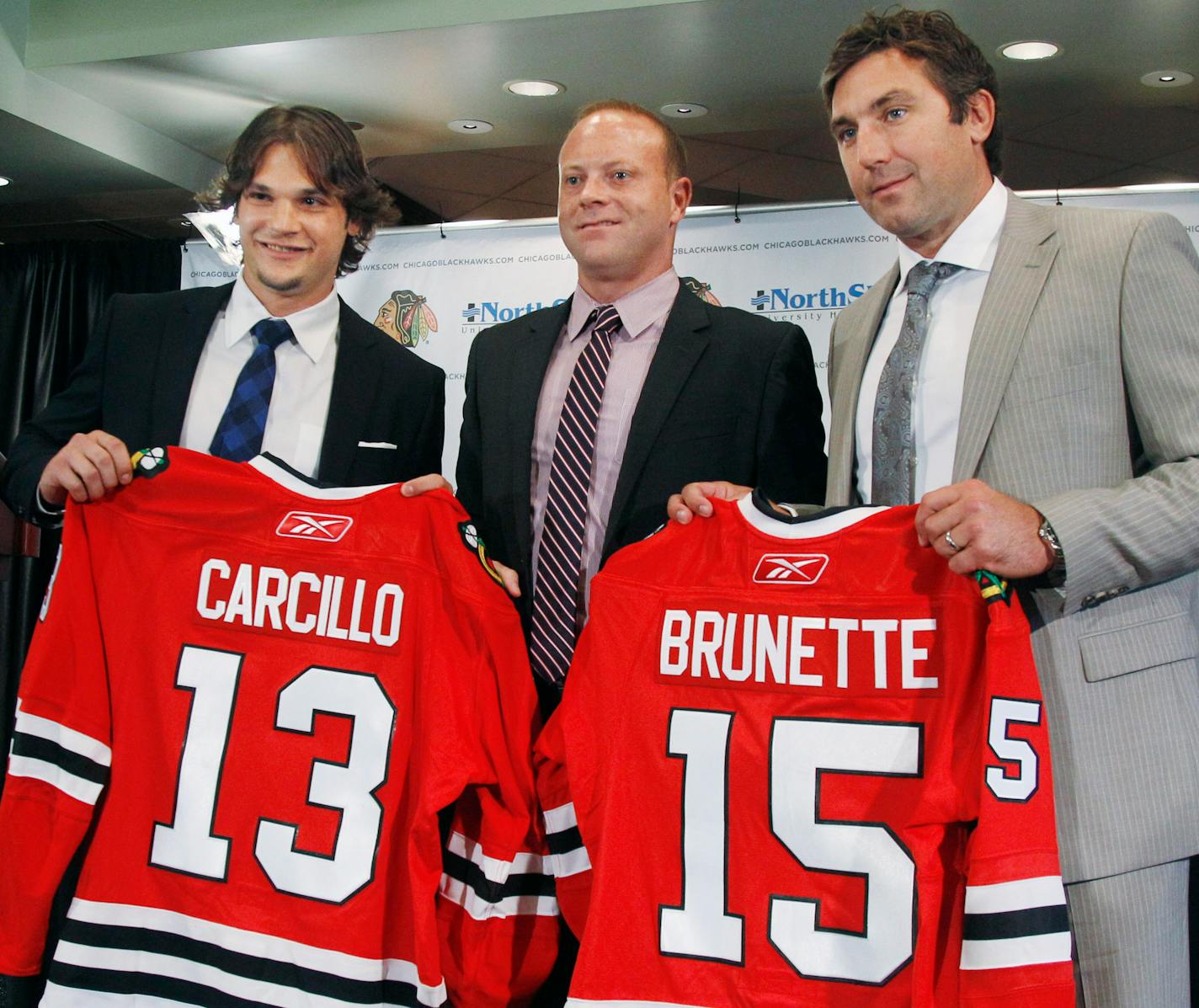 Blackhawks General Manager Stan Bowman, center, introduced free agent signees Daniel Carcillo, left, and Andrew Brunette during a news conference Monday.