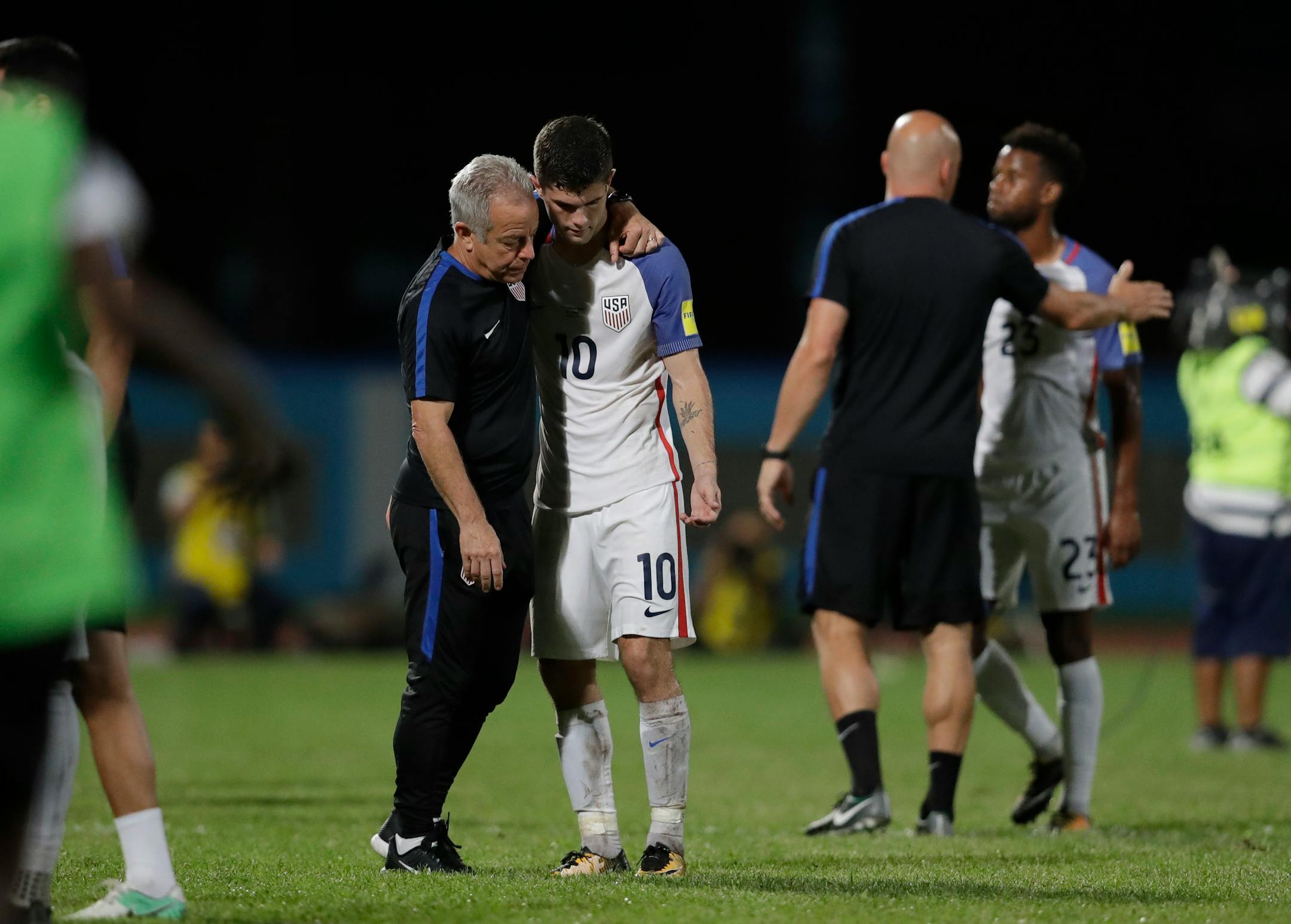 United States' Christian Pulisic, (10) is comforted after losing 2-1 against Trinidad and Tobago during a 2018 World Cup qualifying match